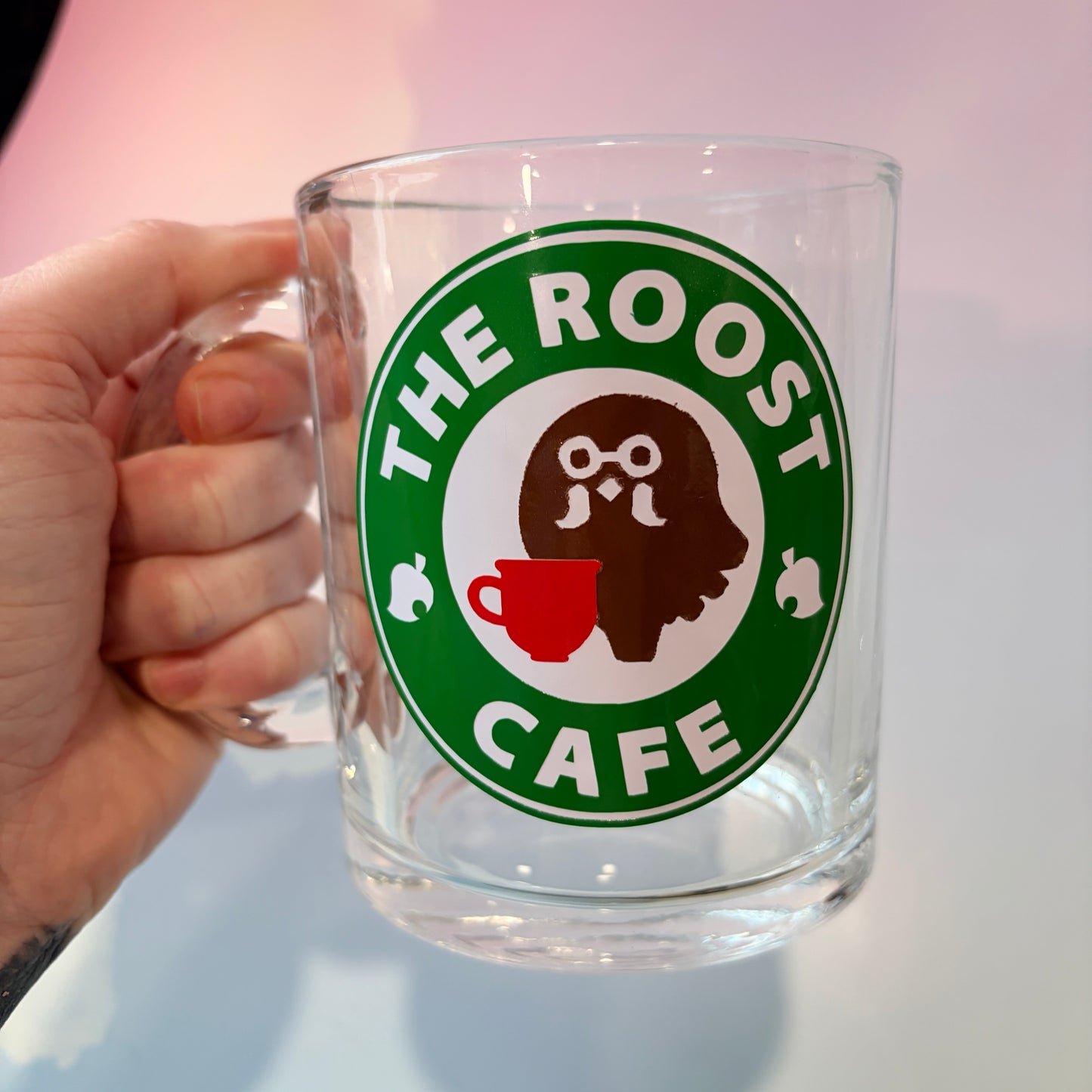 Glass coffee cup with Roost Café inspired vinyl logo.