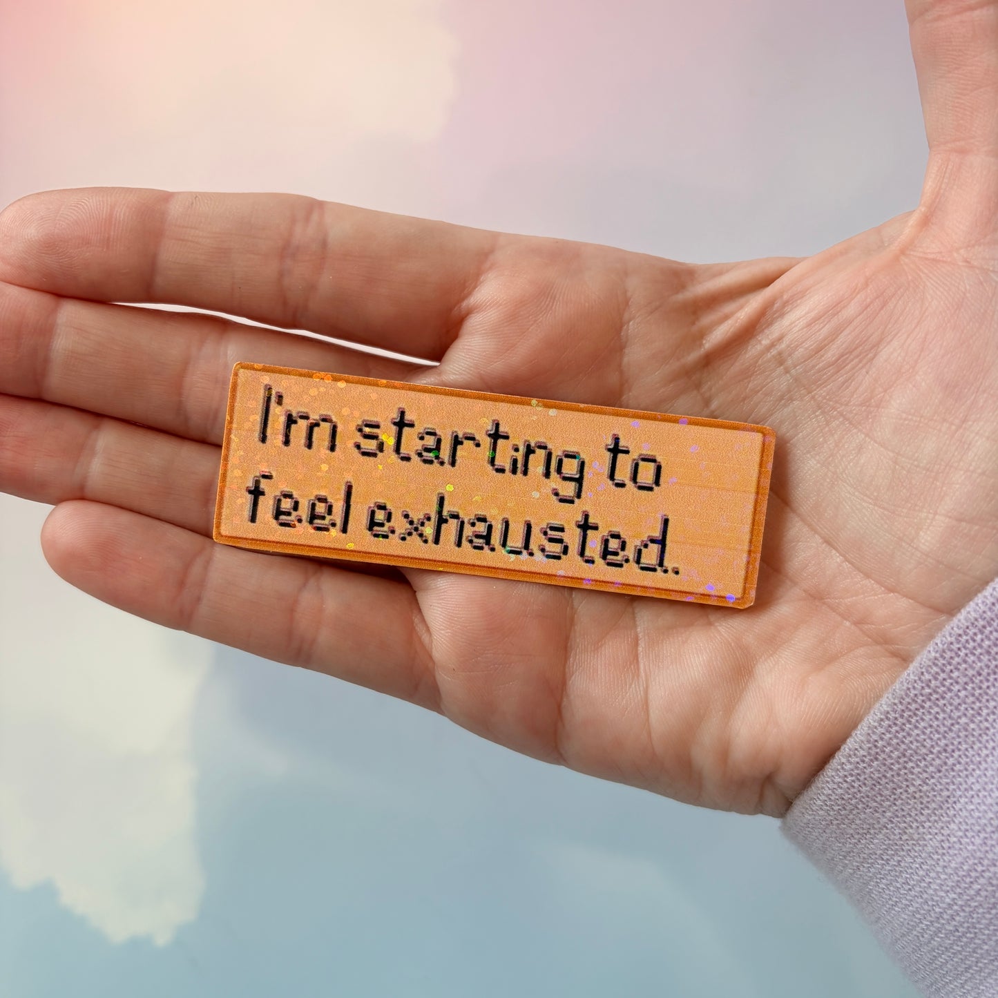 Holographic Stardew Valley sticker with the phrase “I'm starting to feel exhausted.” Shiny gamer vinyl decal perfect for laptops, water bottles, journals, and cozy gaming fans.