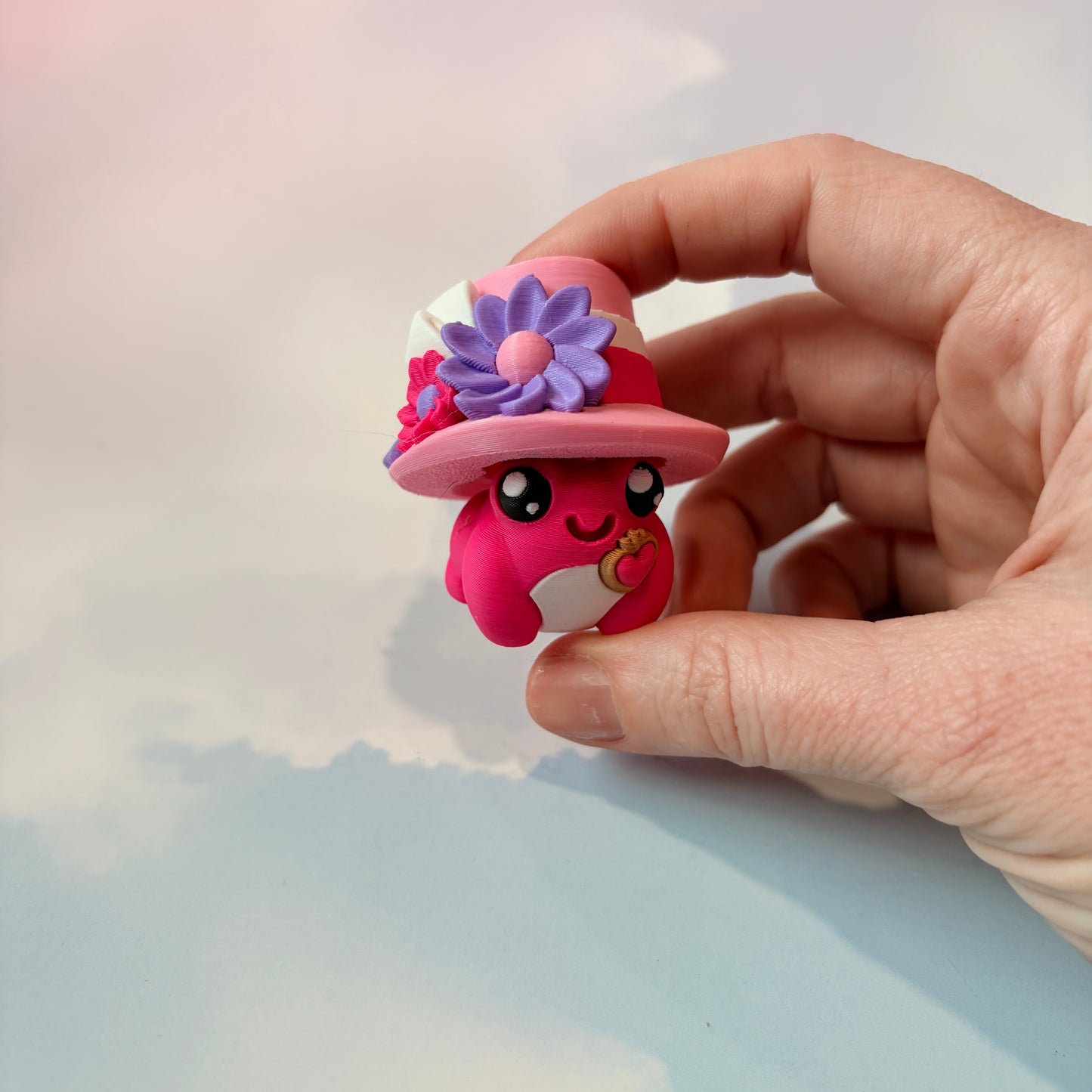 Cute frog fidget clickers with hats and accessories.