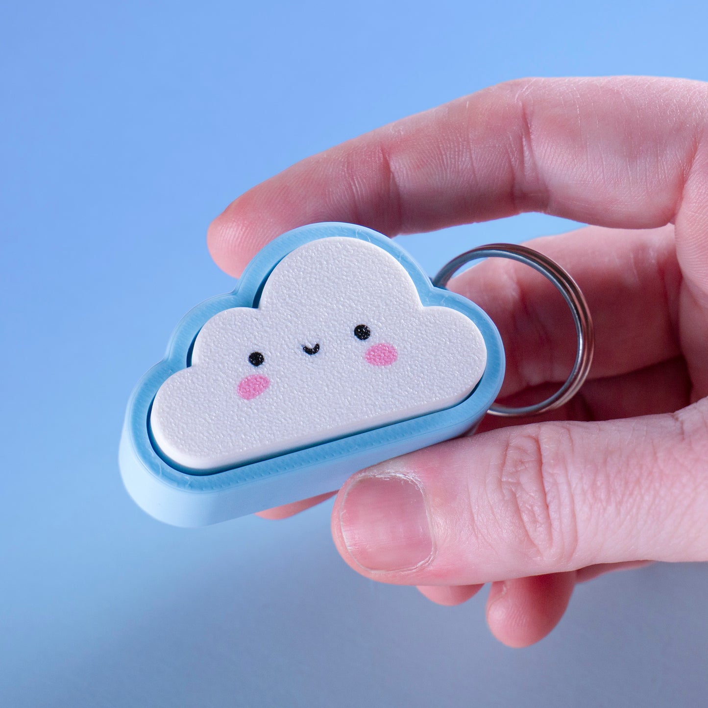 Kawaii cloud fidget clicker keychain with blushing cheeks and a smile, perfect for stress relief, gamer gifts, or cute everyday carry.