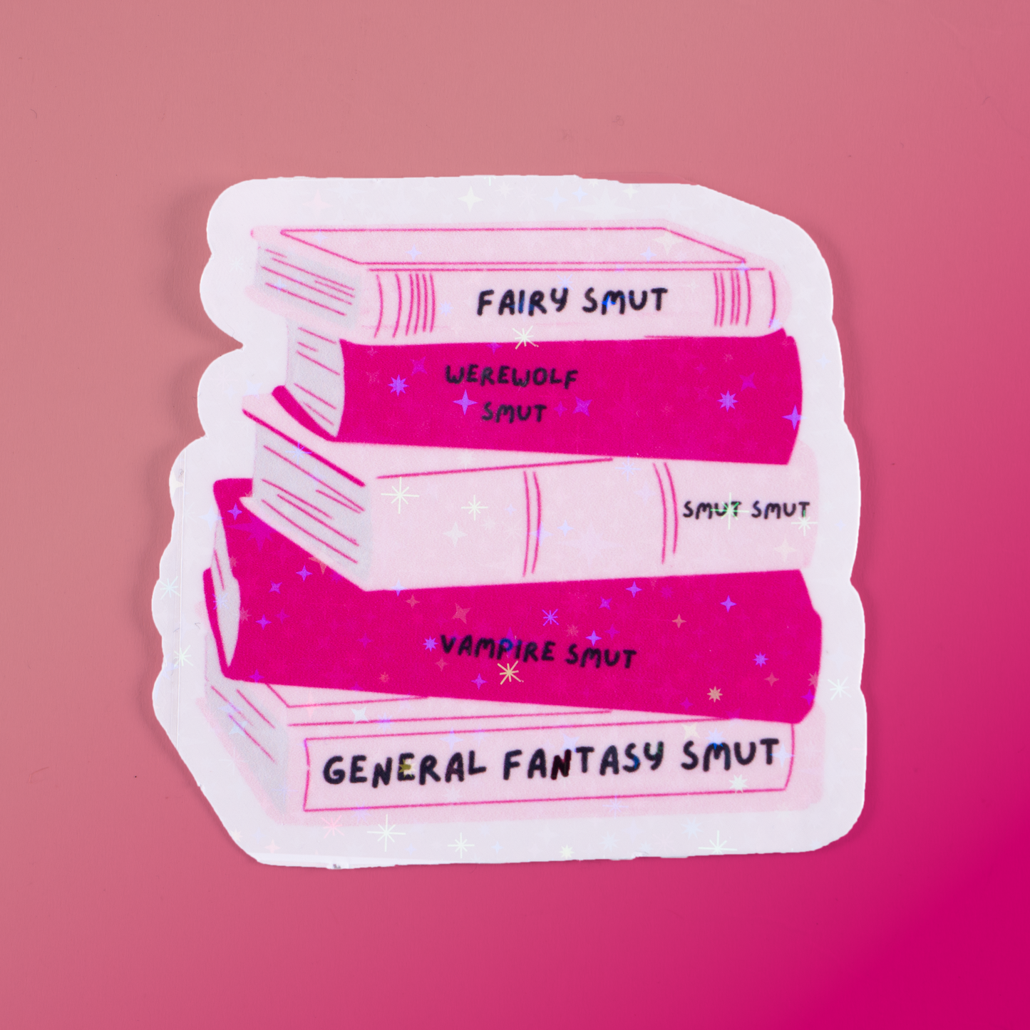 Holographic sticker featuring a pink book stack labeled Fairy Smut, Werewolf Smut, Vampire Smut, and more. A must-have for fantasy romance and spicy book lovers!
