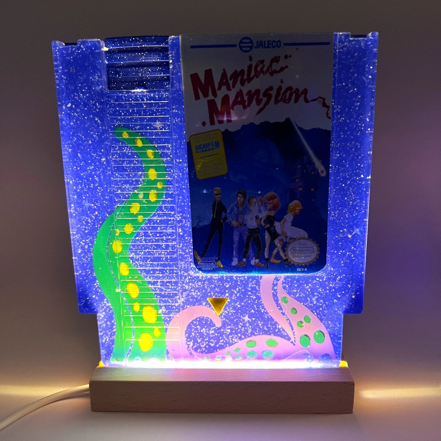 Handmade custom Maniac Mansion NES cartridge art, featuring a starry night background and iconic tentacles from the game. Perfect for displaying as unique gamer decor or a gift for retro game enthusiasts.