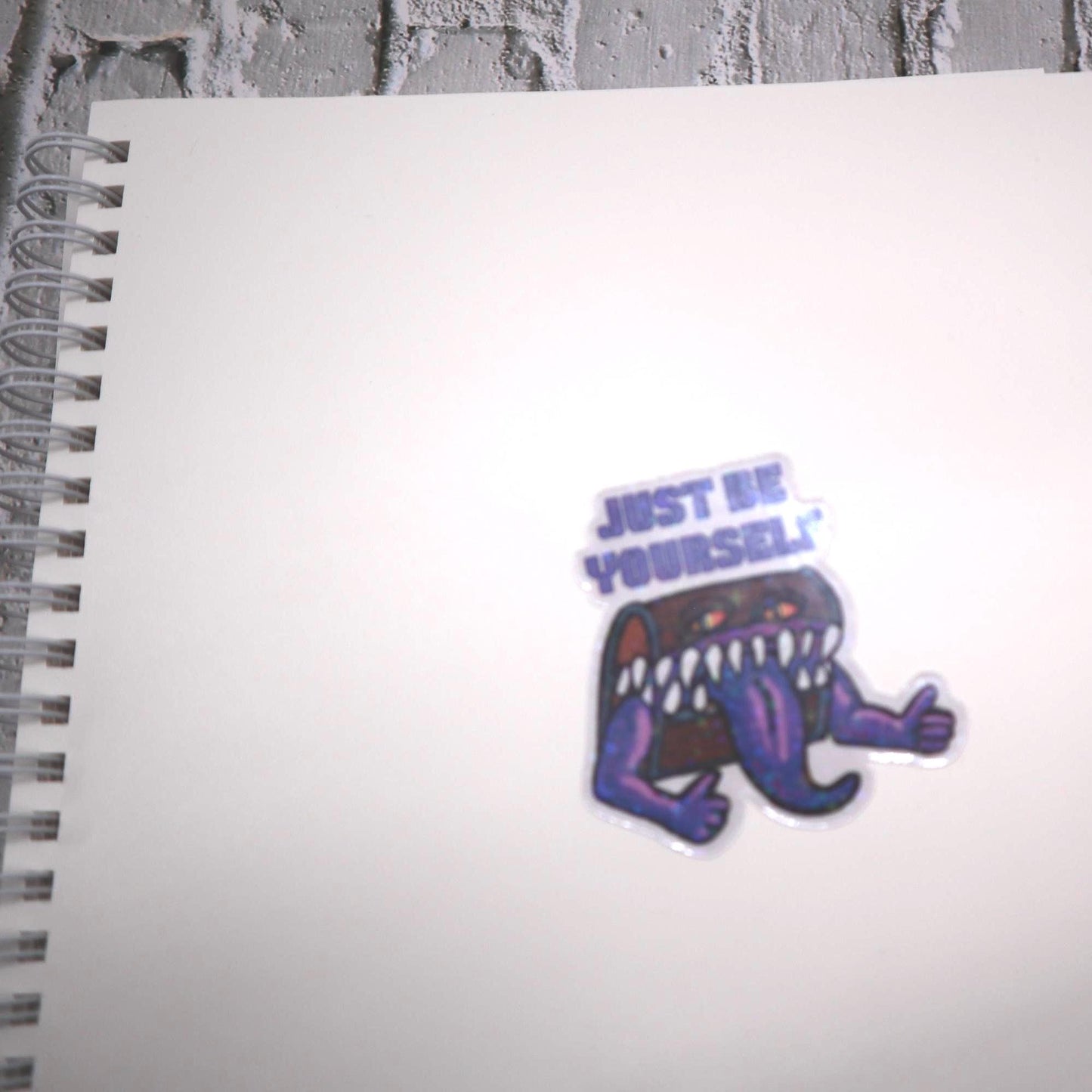 Holographic DnD mimic sticker with a grinning treasure chest and the phrase Just Be Yourself, perfect for laptops, water bottles, and tabletop RPG fans.