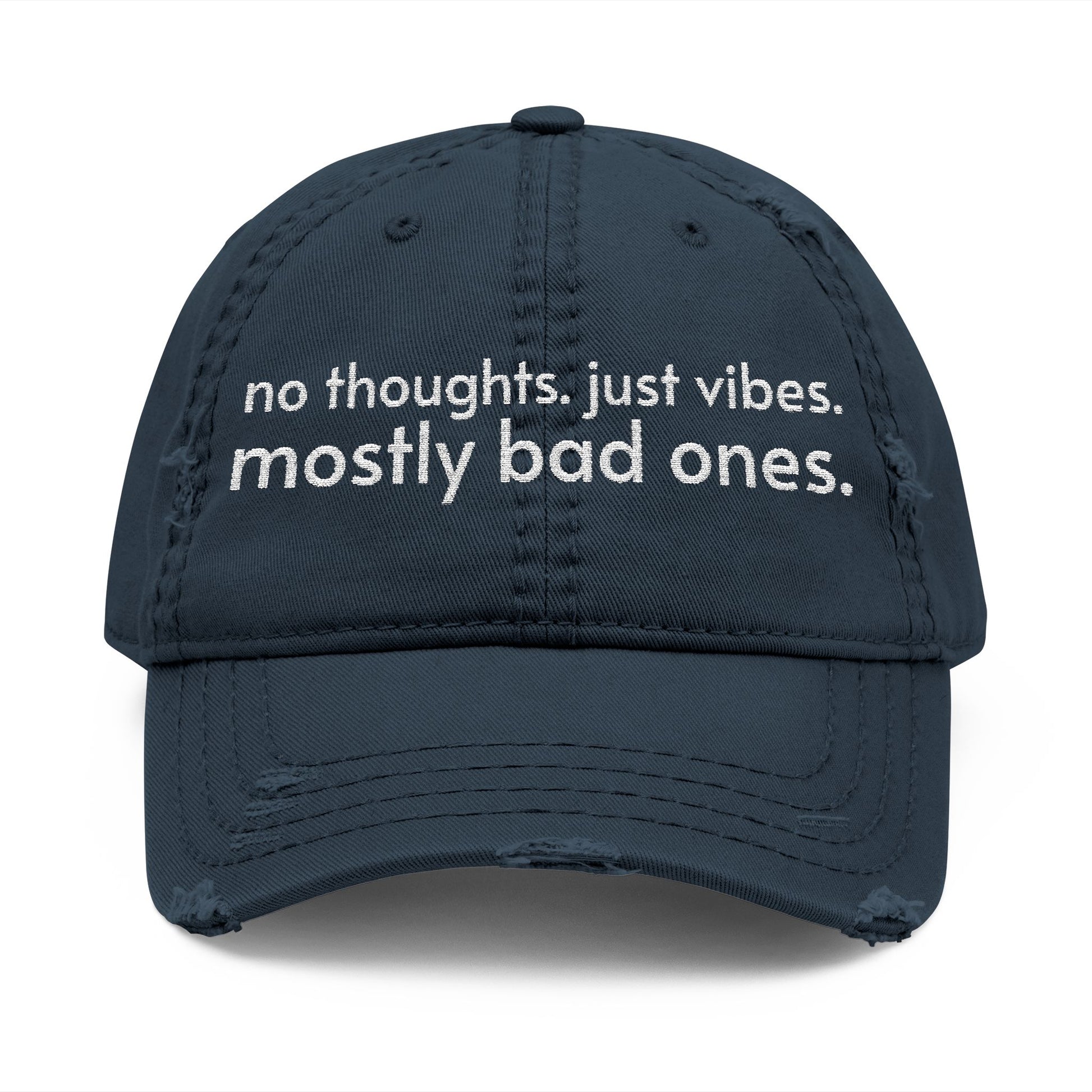 Distressed ball cap embroidered with “no thoughts just vibes mostly bad ones”.