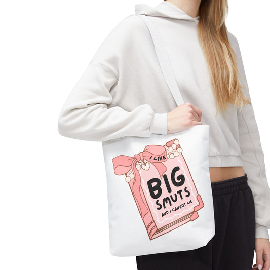 White tote bag with a pink book illustration and the phrase "I Like Big Smuts and I Cannot Lie." Perfect for romance readers, book lovers, and smut enthusiasts.