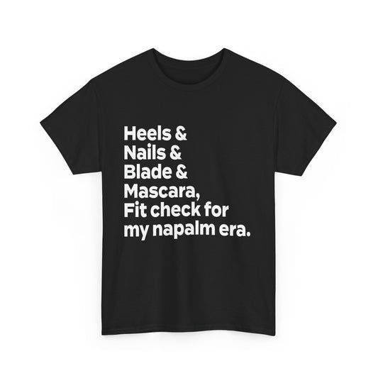 A KPOP Demon Hunters graphic tee featuring the phrase 'heels & nails & blade & mascara, fit check for my napalm era' in bold white lettering.