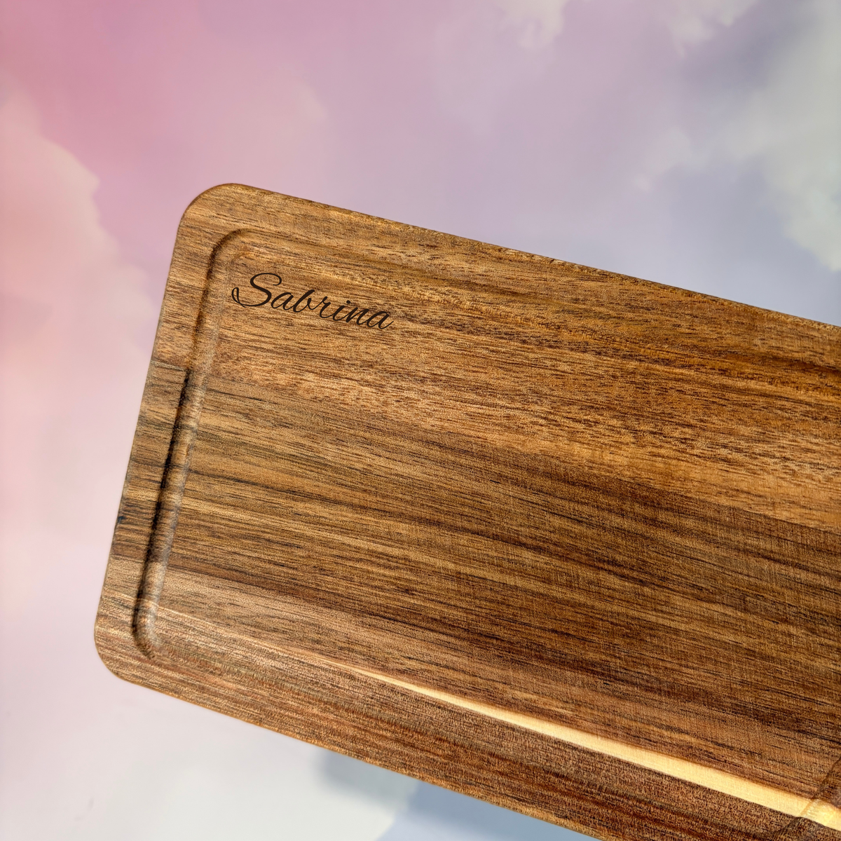 Personalized mini acacia wood charcuterie board with custom laser engraving, approximately 9.5 x 4.7 inches. Includes two serving tools, standard or cursive font options, and gift wrapping for a ready-to-give present.
