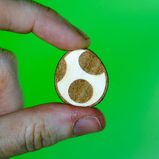 A laser engraved wood pin shaped like a Yoshi Egg. Lightweight and handmade, perfect for gamers, retro lovers, or anyone into cute and geeky accessories.