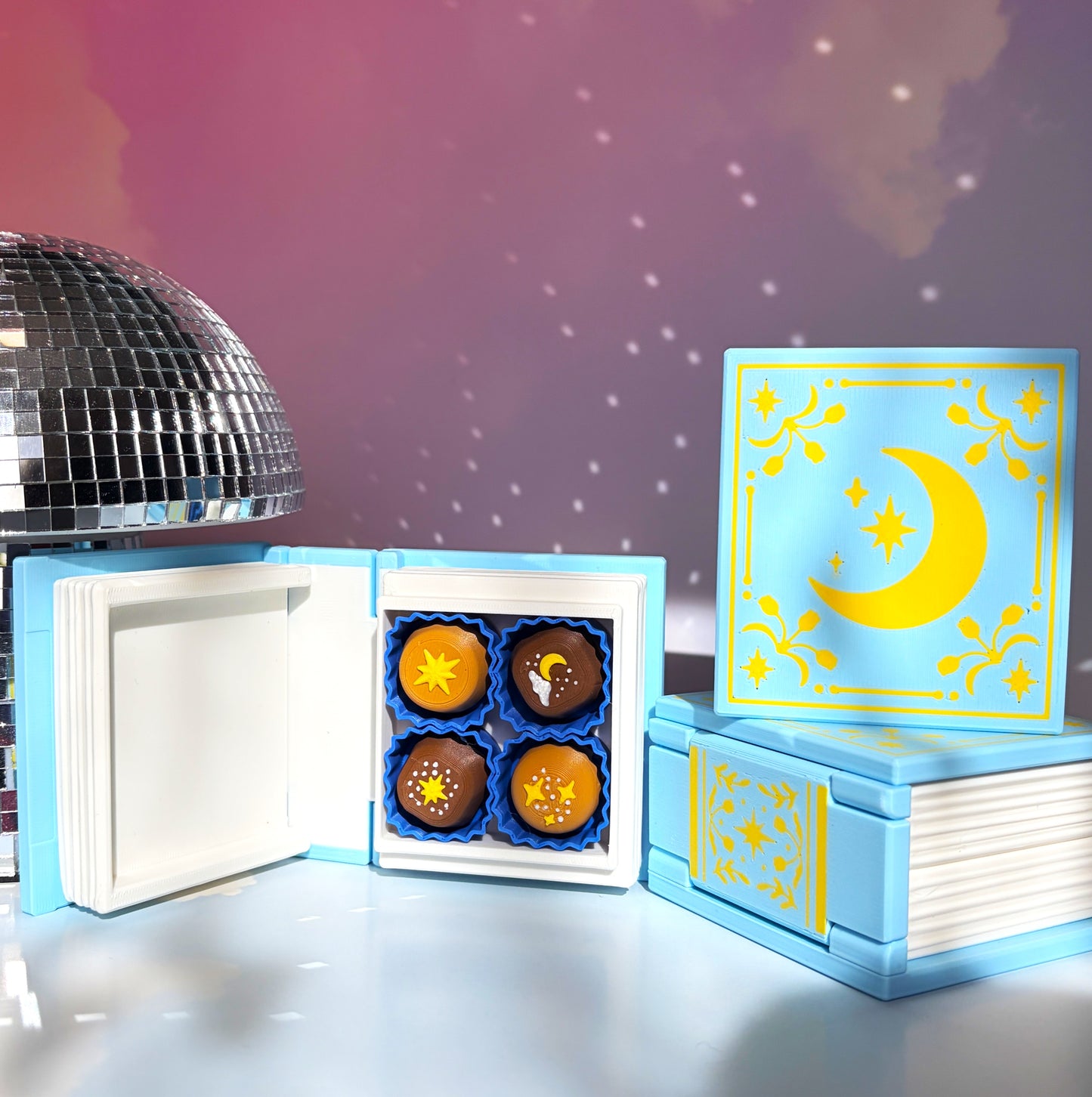 Book-shaped fidget clicker opening to a box of chocolates