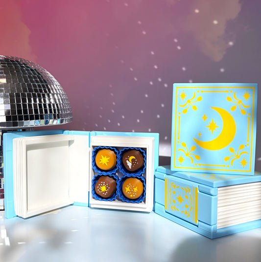 Book-shaped fidget clicker opening to a box of chocolates