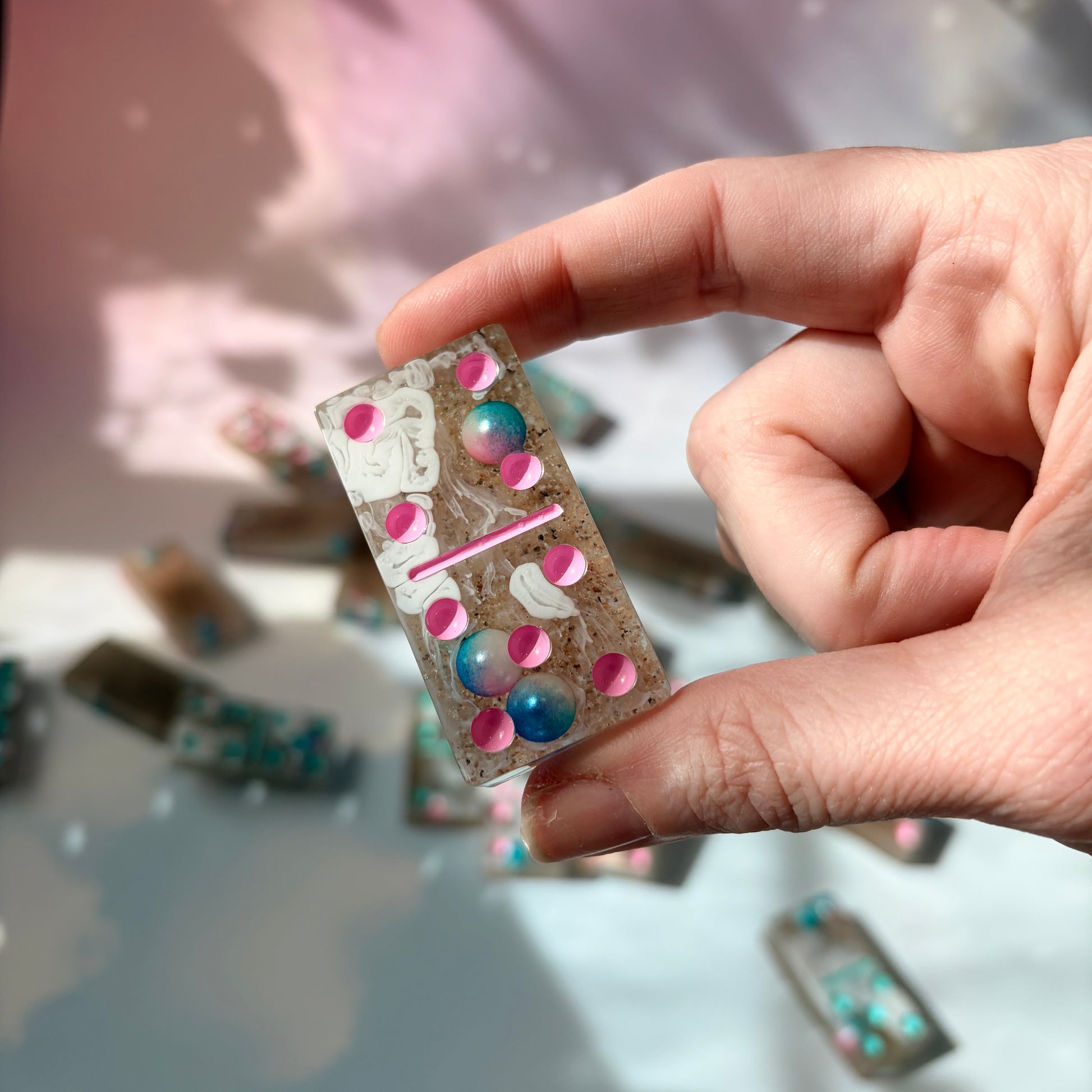 Handmade seashore resin dominoes with pearls and sand.