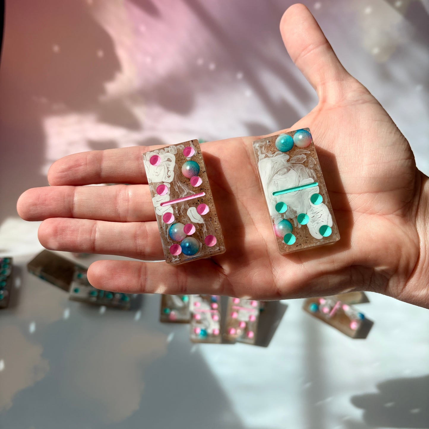 Handmade seashore resin dominoes with pearls and sand.