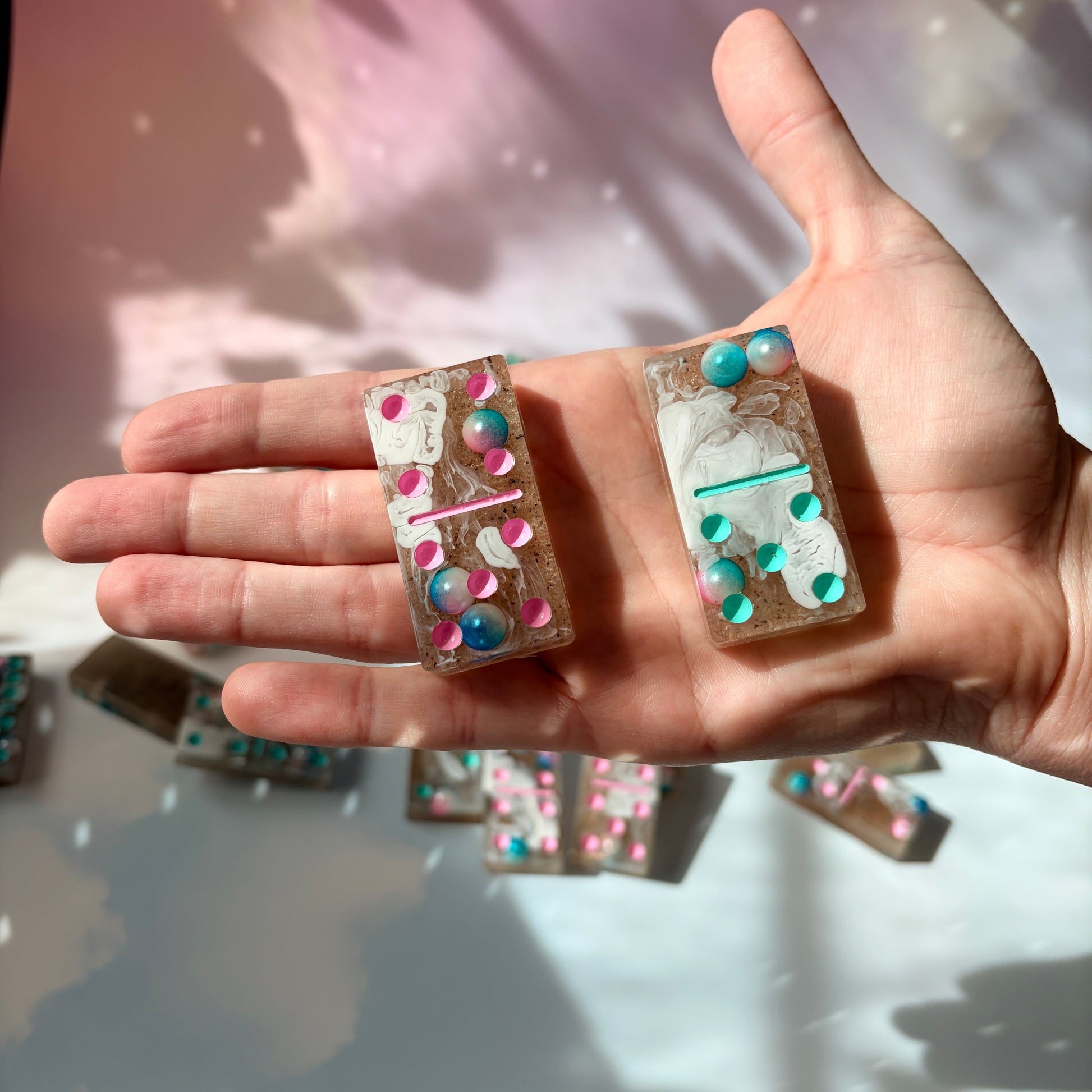 Handmade seashore resin dominoes with pearls and sand.