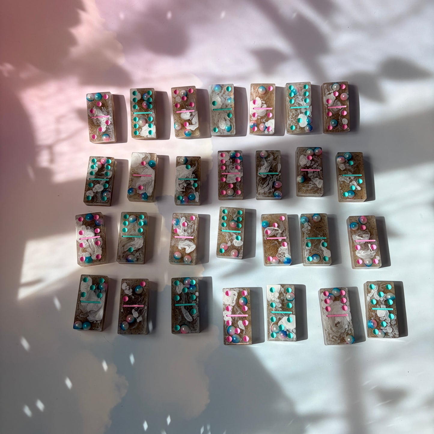Handmade seashore resin dominoes with pearls and sand.
