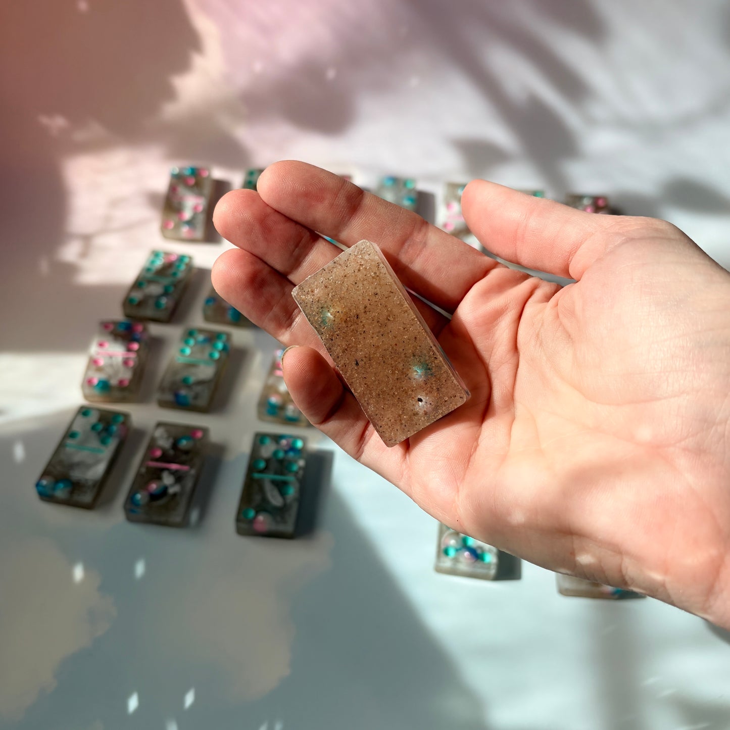 Handmade seashore resin dominoes with pearls and sand.
