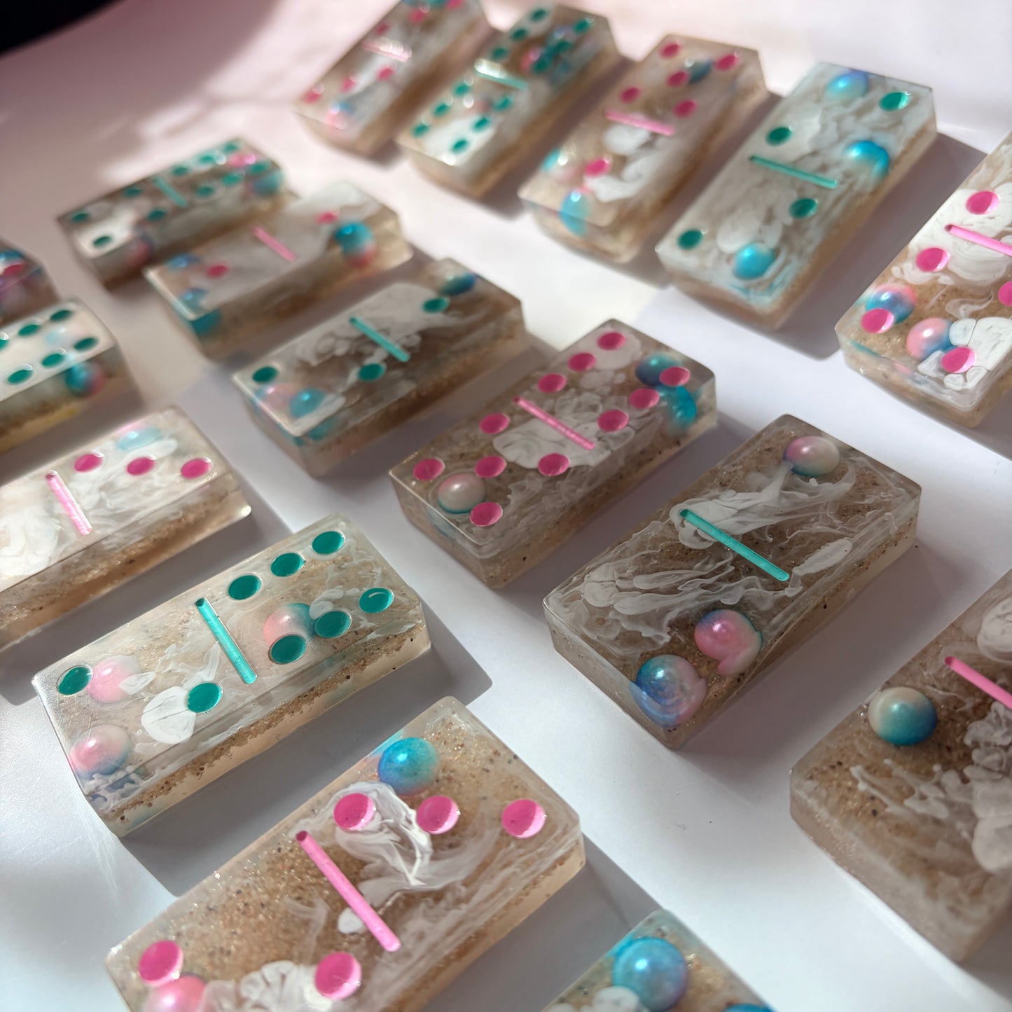 Handmade seashore resin dominoes with pearls and sand.