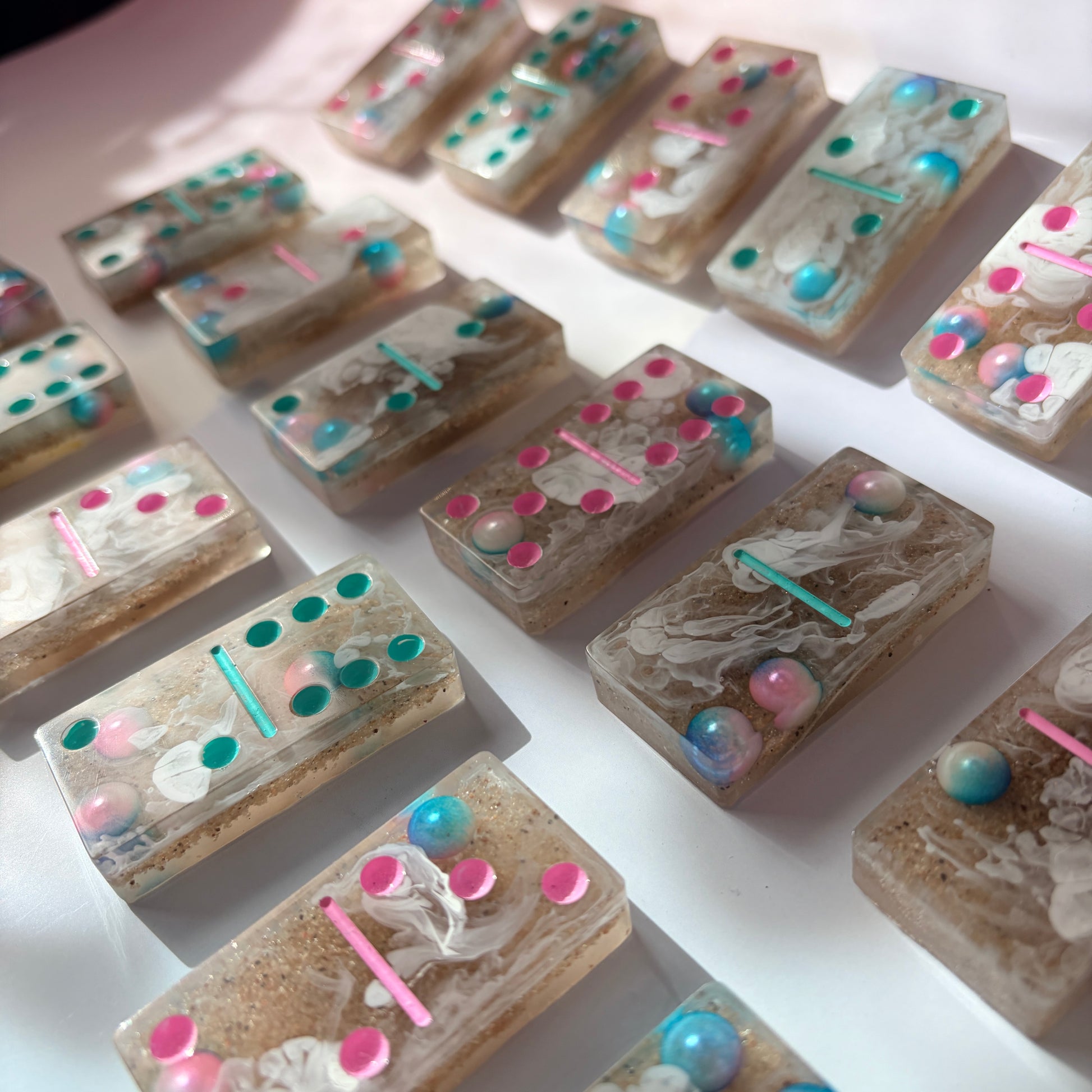 Handmade seashore resin dominoes with pearls and sand.