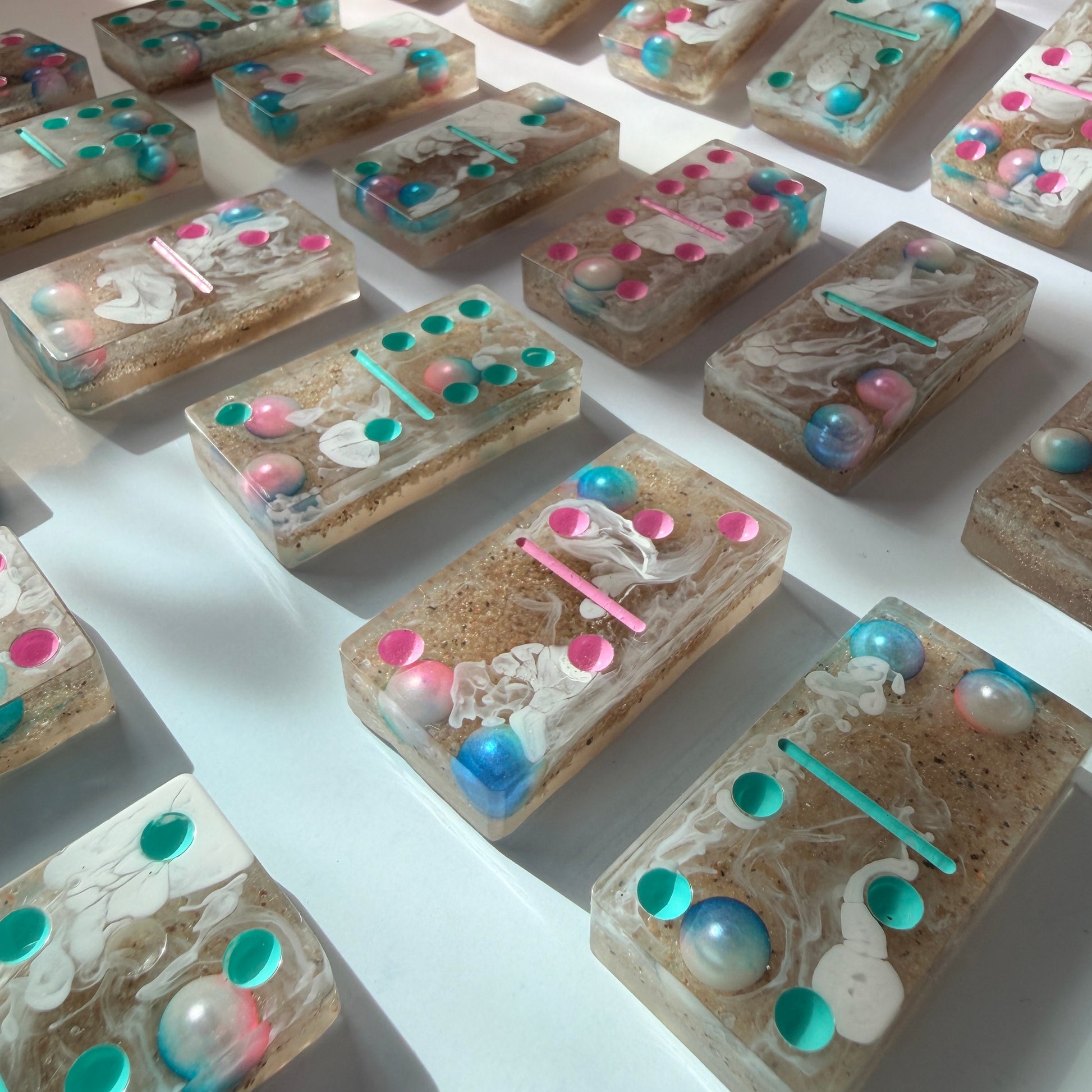 Handmade seashore resin dominoes with pearls and sand.