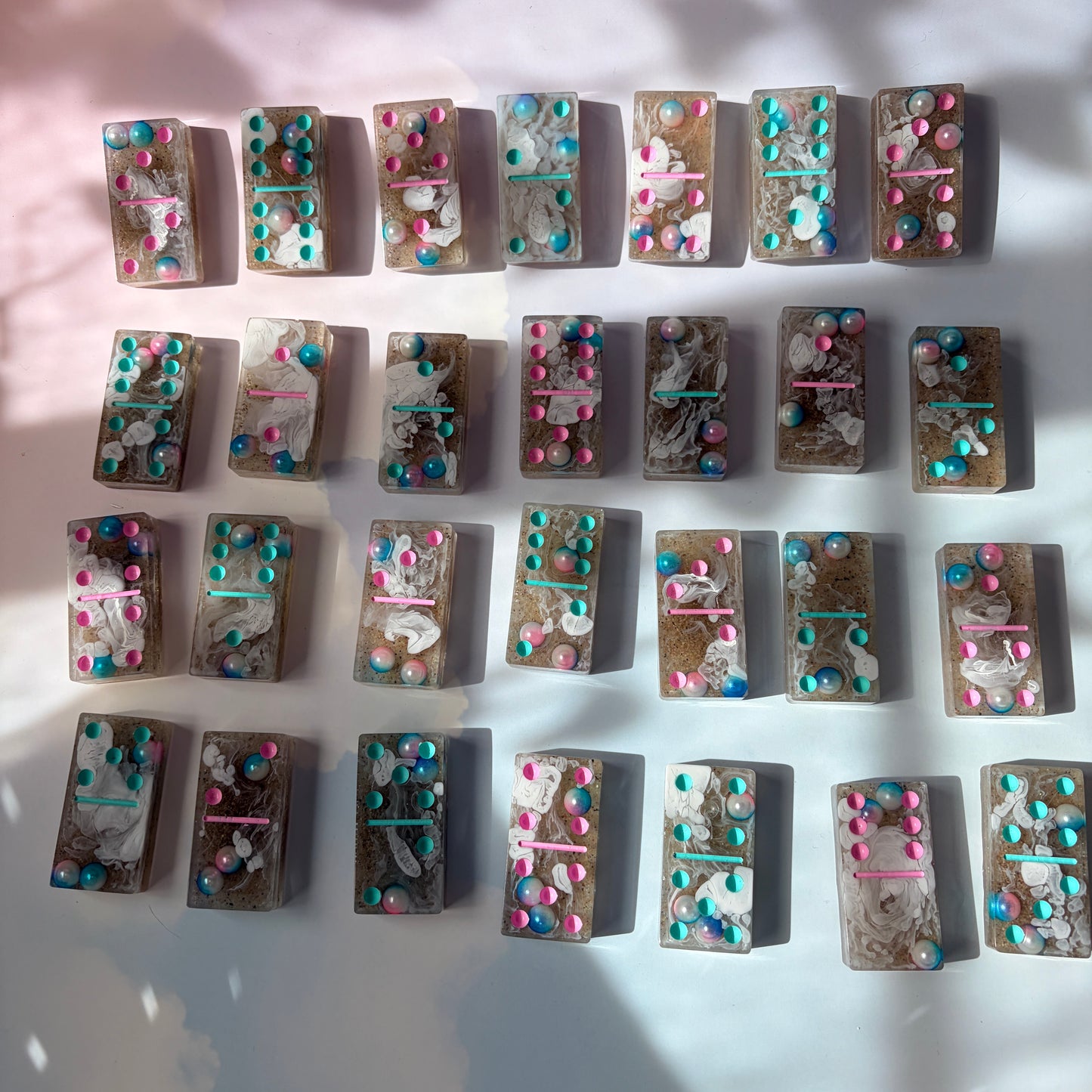 Handmade seashore resin dominoes with pearls and sand.