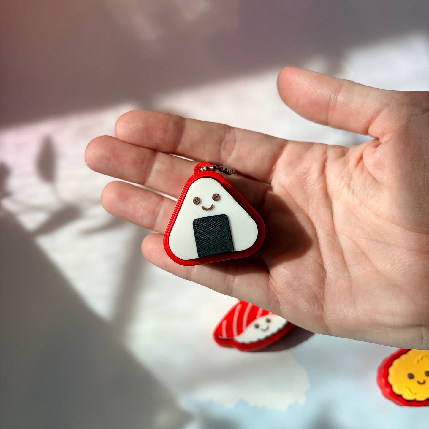 Sushi shaped 3D printed fidget clicker keychain. 