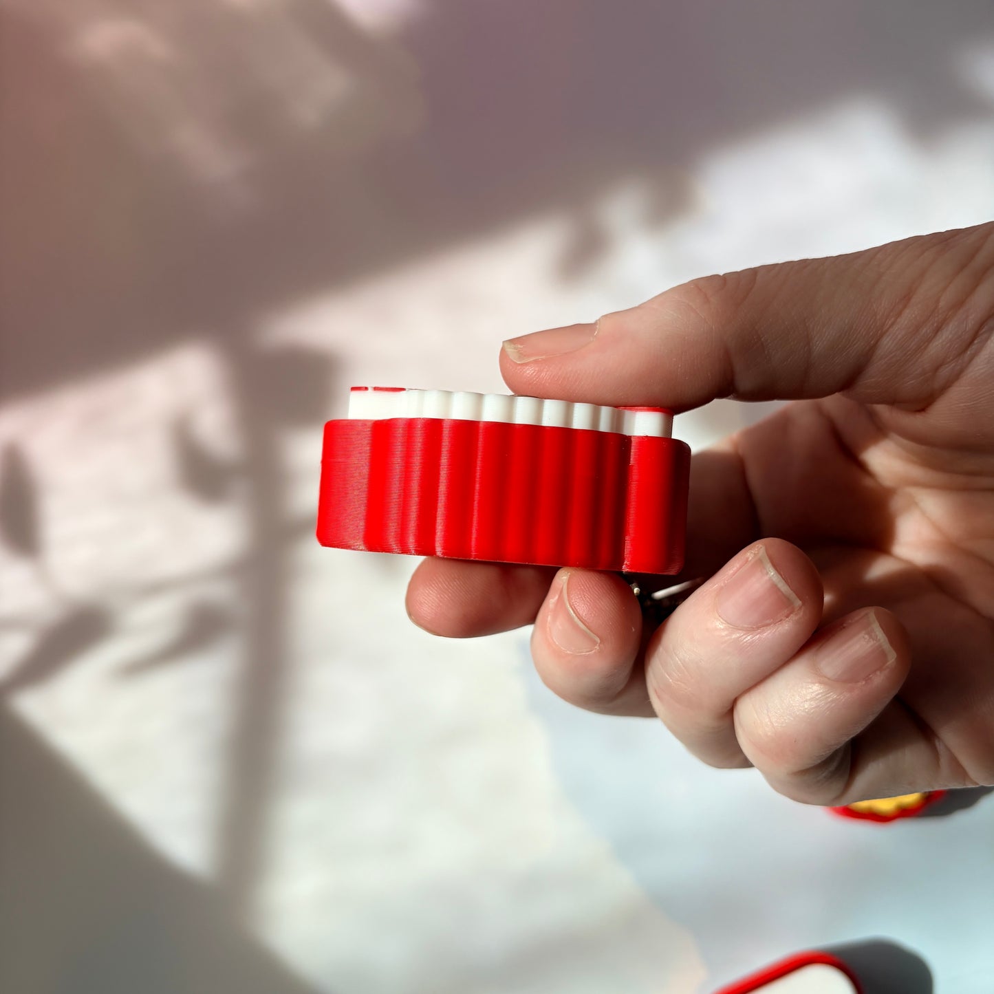Sushi shaped 3D printed fidget clicker keychain. 