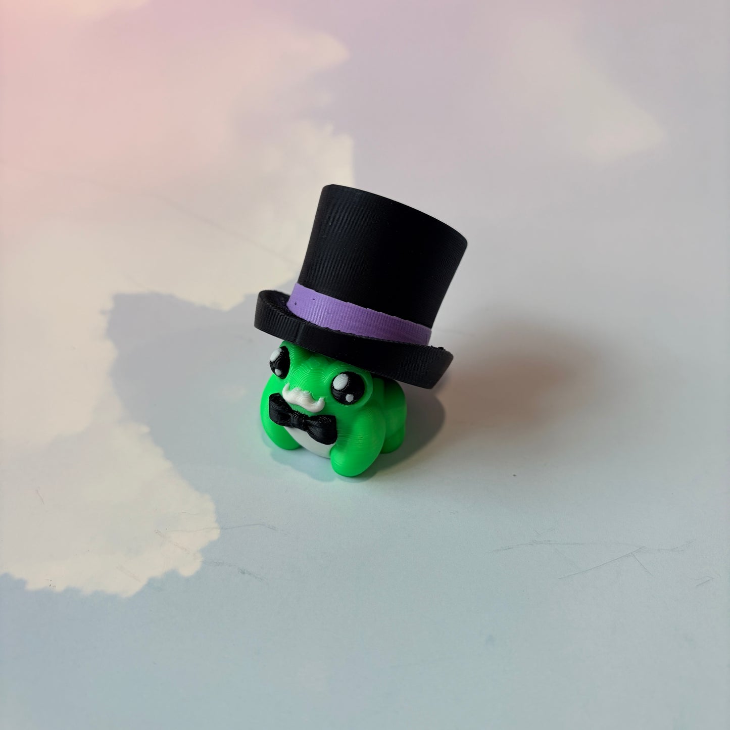 Cute frog fidget clickers with hats and accessories.