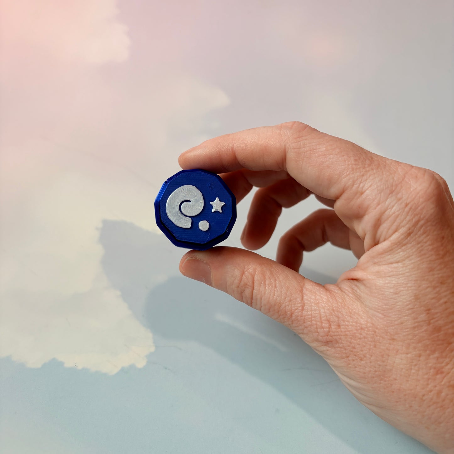 Blue animal crossing fossil themed fidget clicker with white design.
