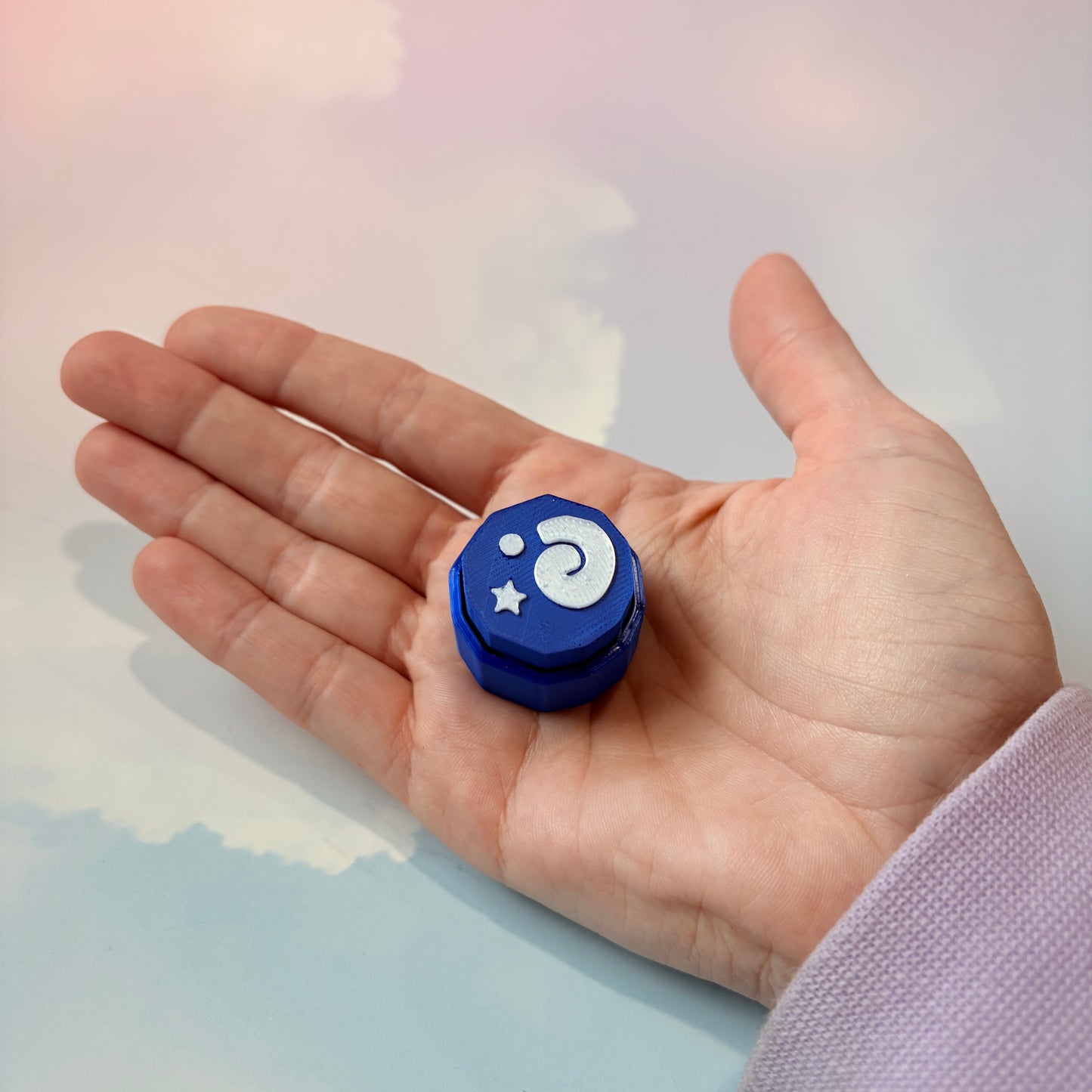 Blue animal crossing fossil themed fidget clicker with white design.