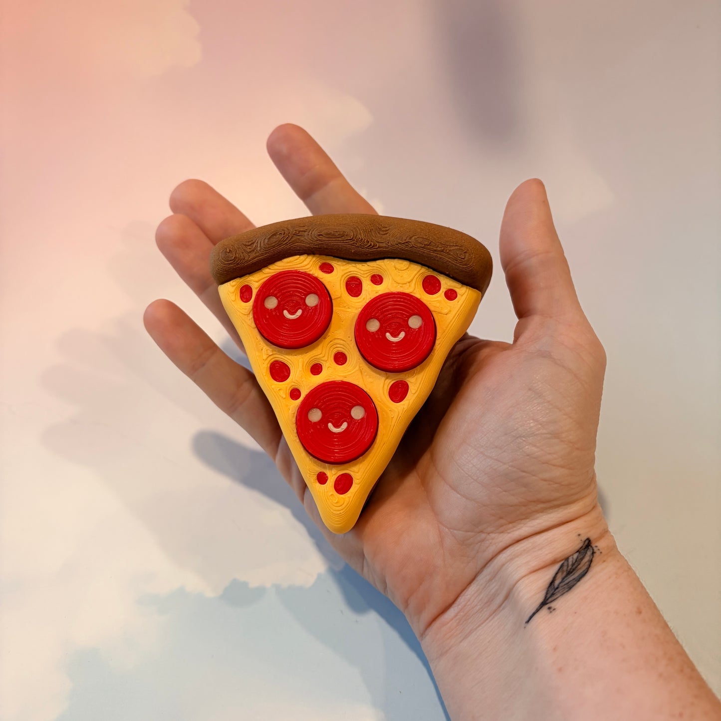 Pizza slice fidget clicker with smiley pepperoni toppings.