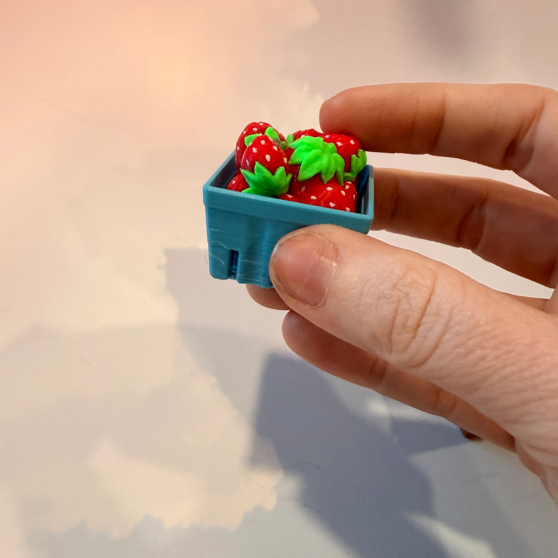 Farmers market themed fidget clicker featuring strawberries and frogs.