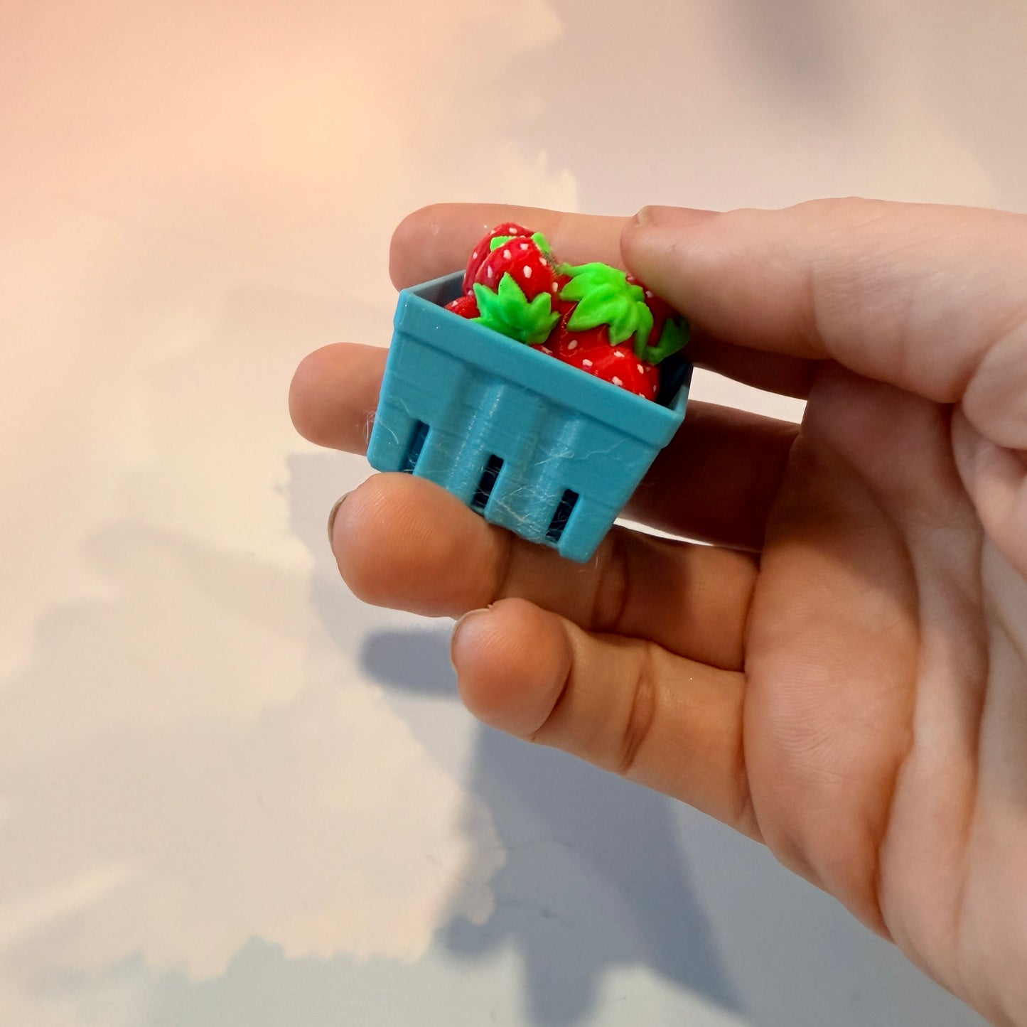 Farmers market themed fidget clicker featuring strawberries and frogs.
