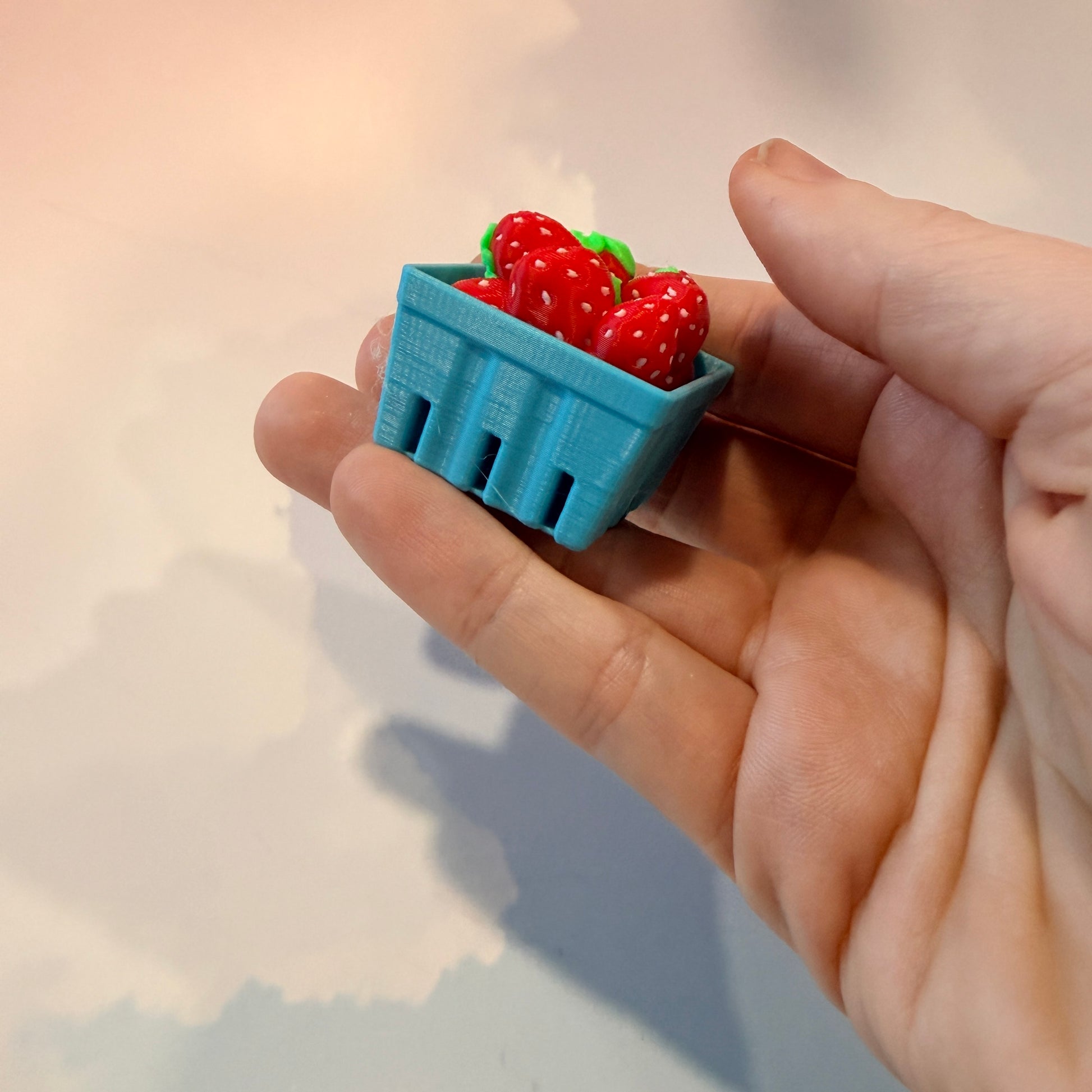 Farmers market themed fidget clicker featuring strawberries and frogs.