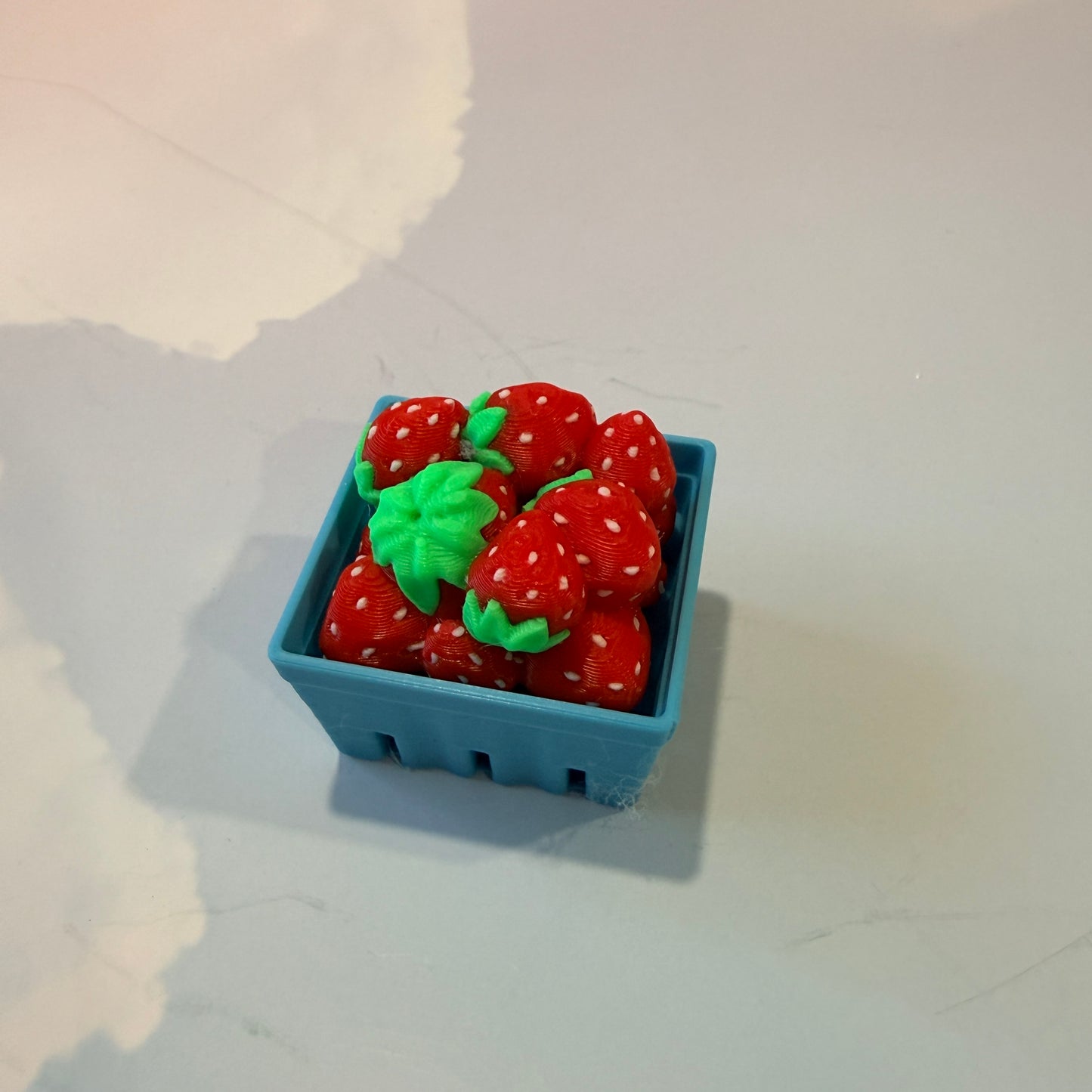 Farmers market themed fidget clicker featuring strawberries and frogs.