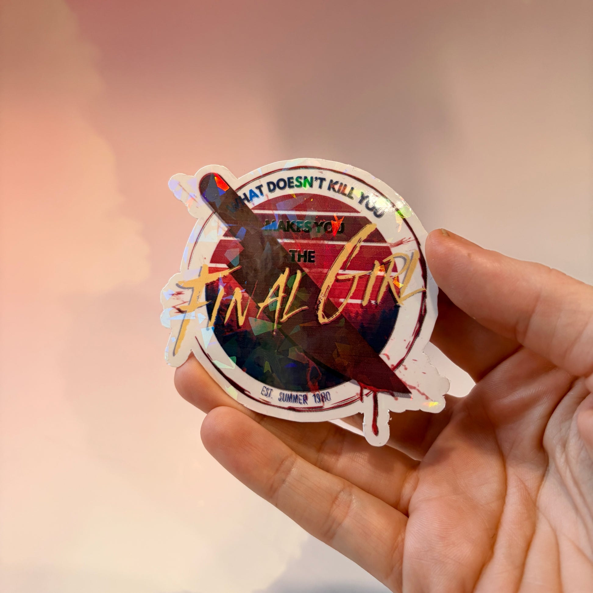 Sticker with text 'What doesn't kill you makes you the final girl' and a knife on a white background