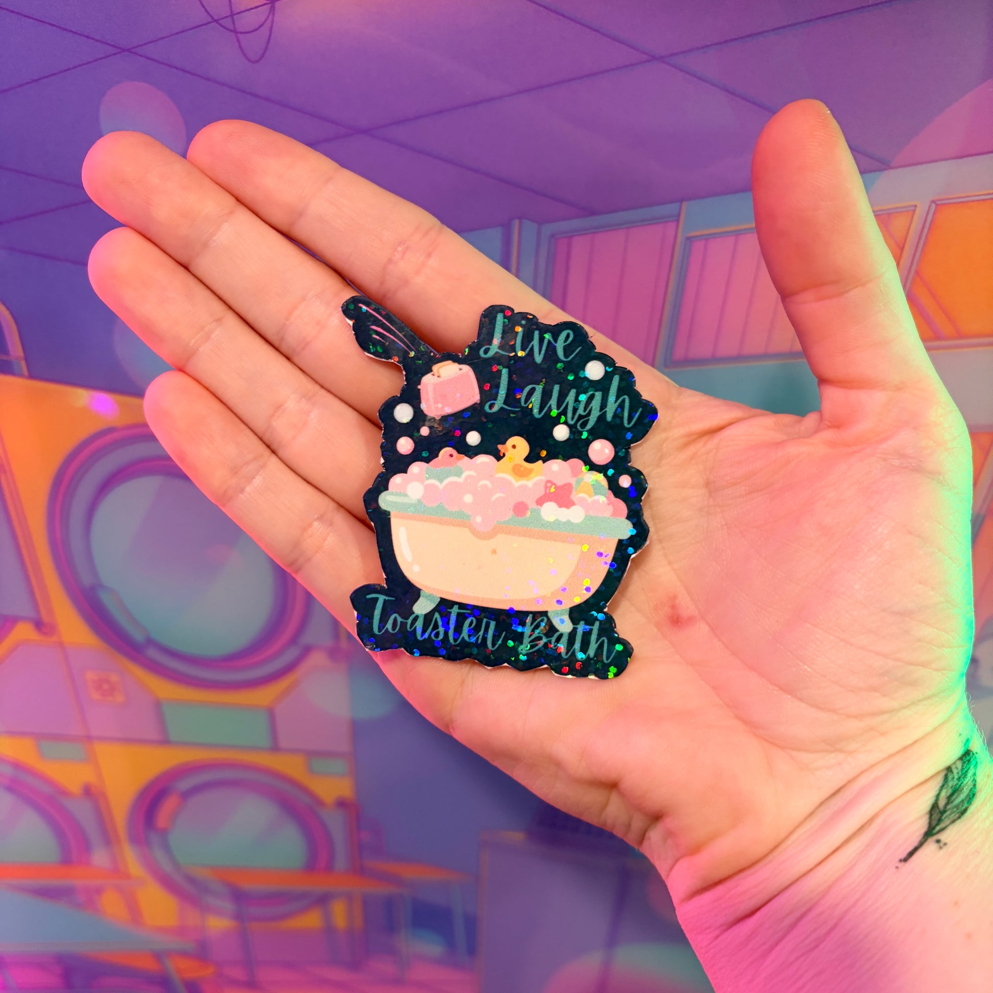 Holographic Live Laugh Toaster Bath vinyl sticker with bathtub, bubbles, rubber duck, and flying toaster.