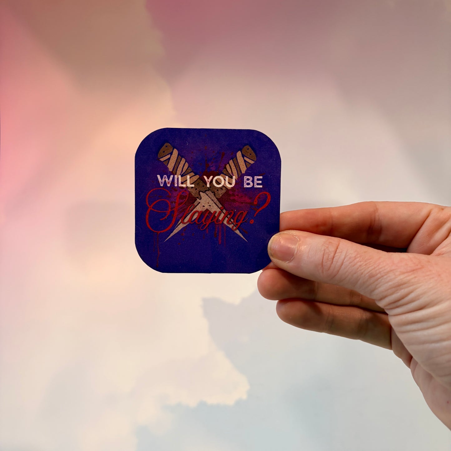 Vinyl sticker featuring two crossed wooden stakes with the phrase "Will You Be Slaying?" in a gothic romance design, weather and water resistant.