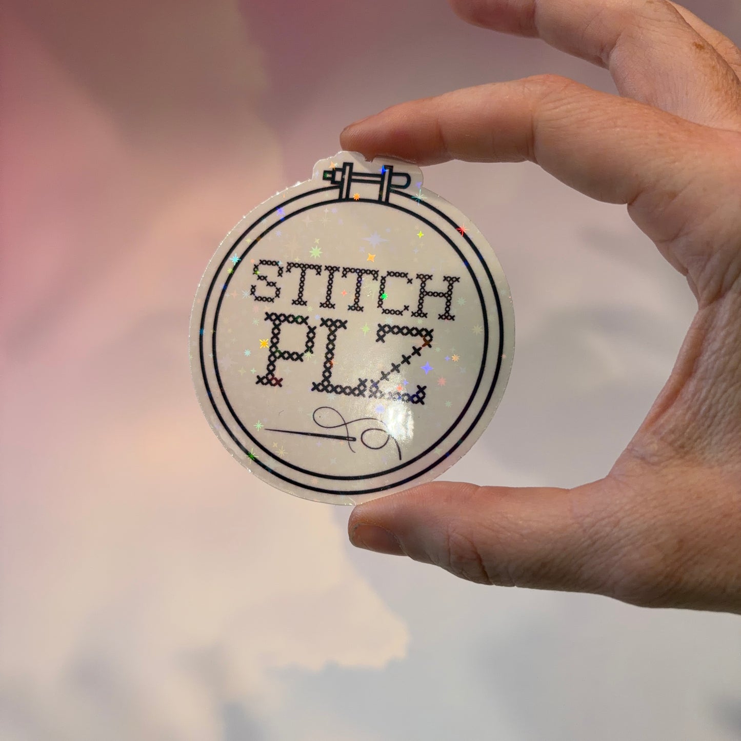 Black and white holographic vinyl sticker featuring a cross stitch hoop with the phrase "STITCH, PLZ," weather and water resistant.