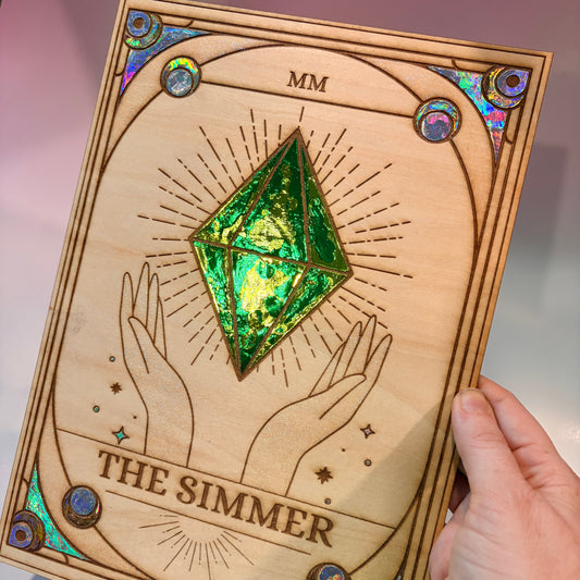 Large laser engraved wooden tarot card featuring a colorful Sims-inspired plumbob with holographic gold and silver foil accents.