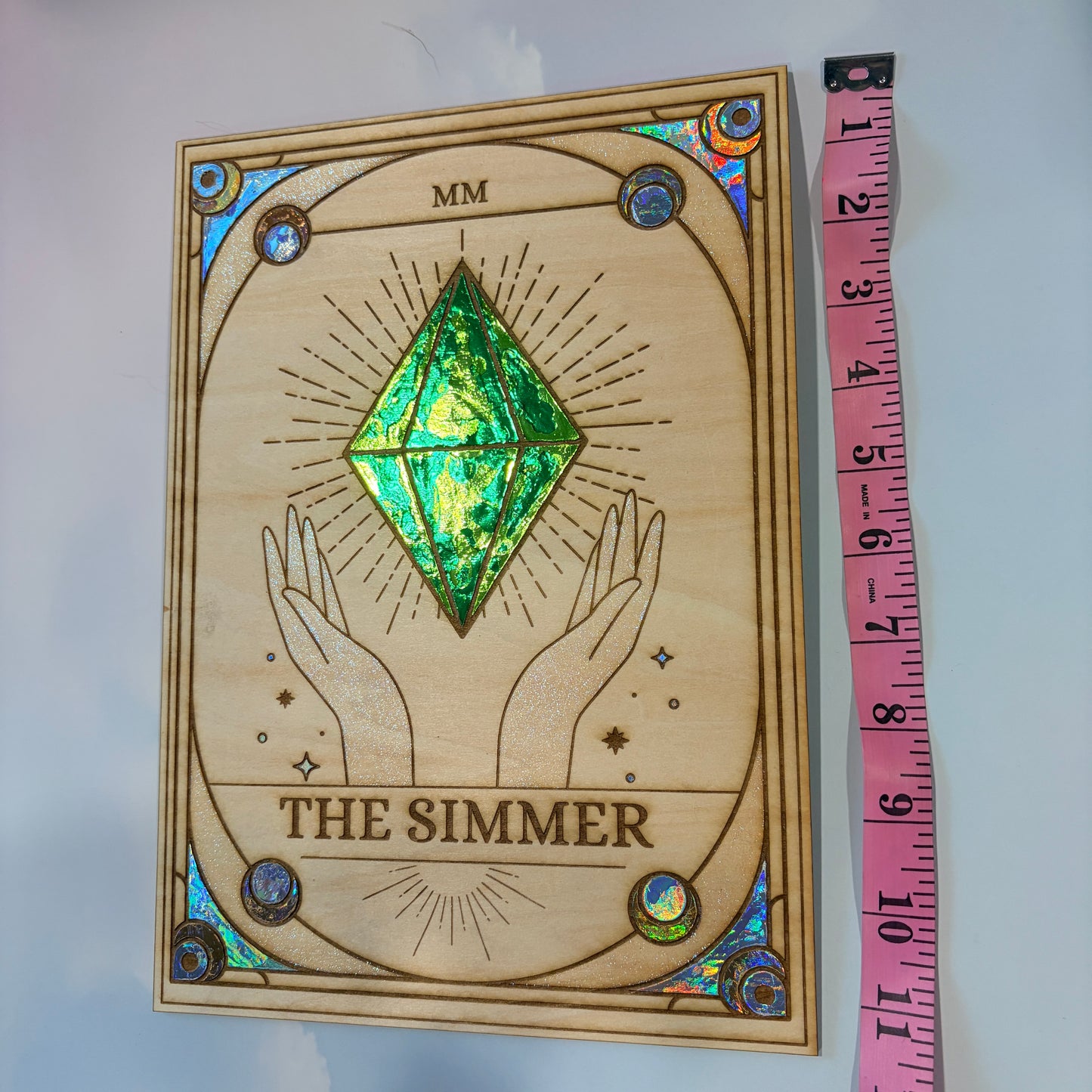Large laser engraved wooden tarot card featuring a colorful Sims-inspired plumbob with holographic gold and silver foil accents.