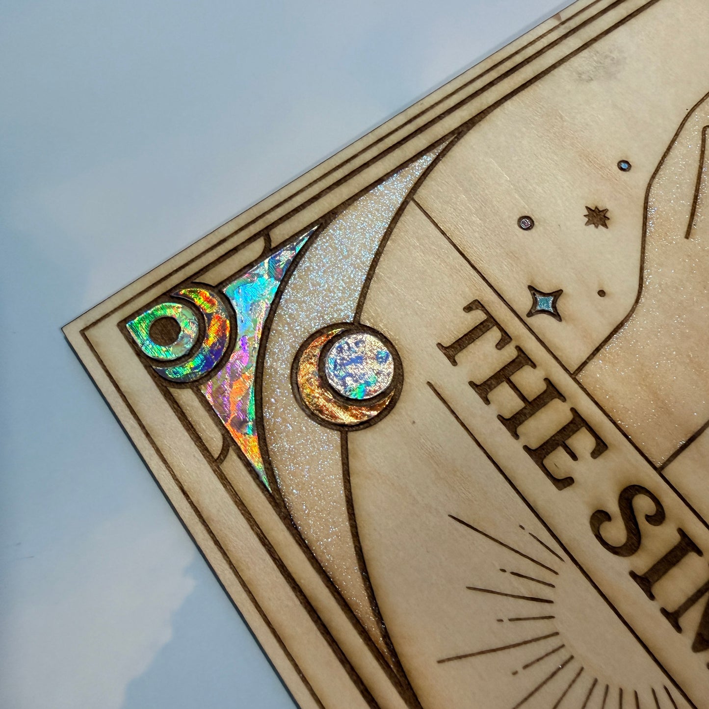 Large laser engraved wooden tarot card featuring a colorful Sims-inspired plumbob with holographic gold and silver foil accents.