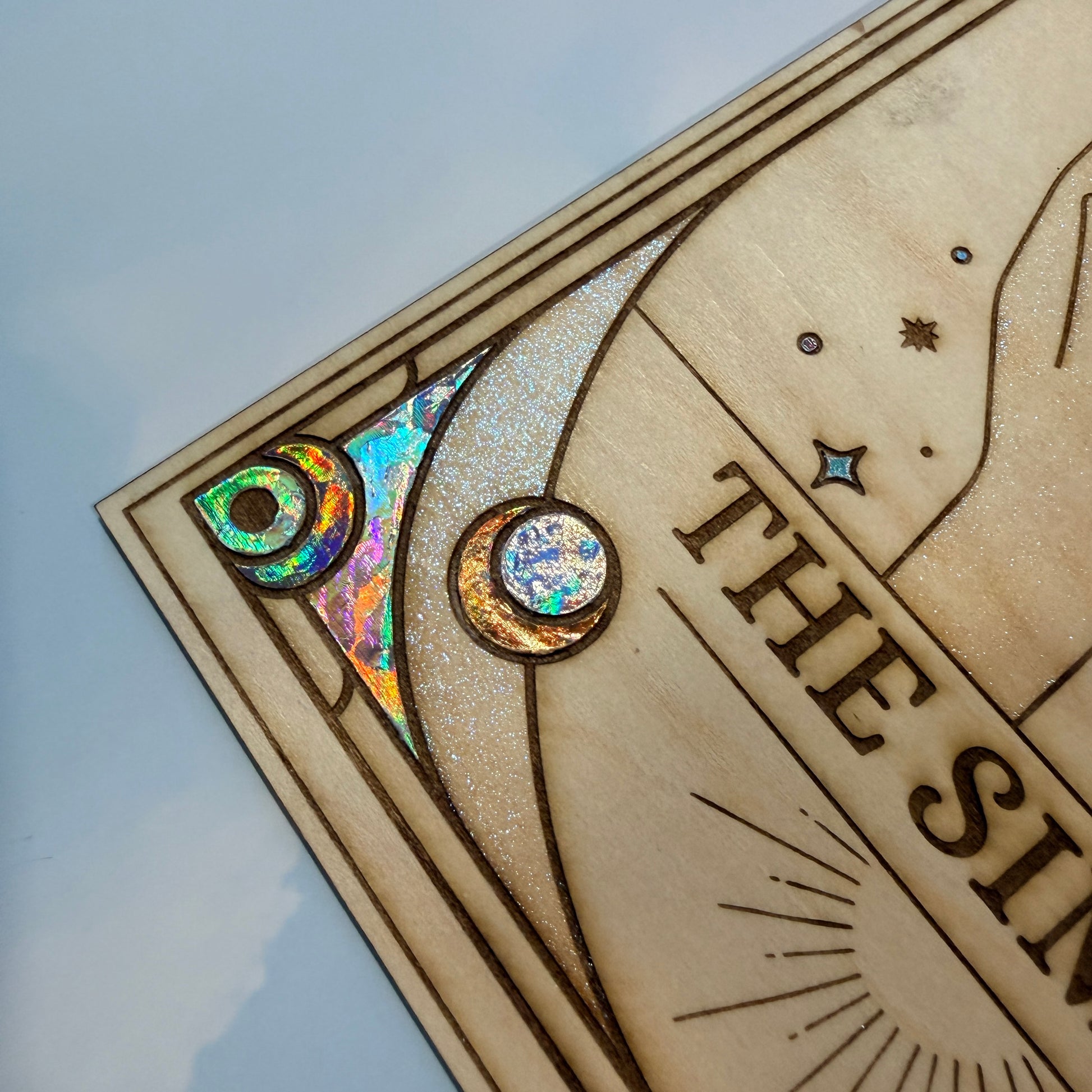 Large laser engraved wooden tarot card featuring a colorful Sims-inspired plumbob with holographic gold and silver foil accents.