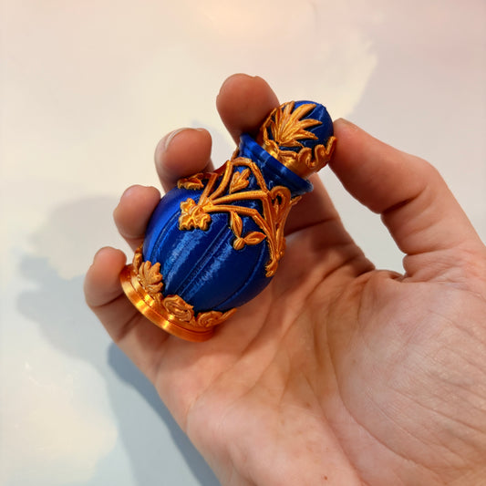Royal blue and gold 3D printed potion bottle fidget clicker with ornate fantasy details, available in clicky or silent versions.