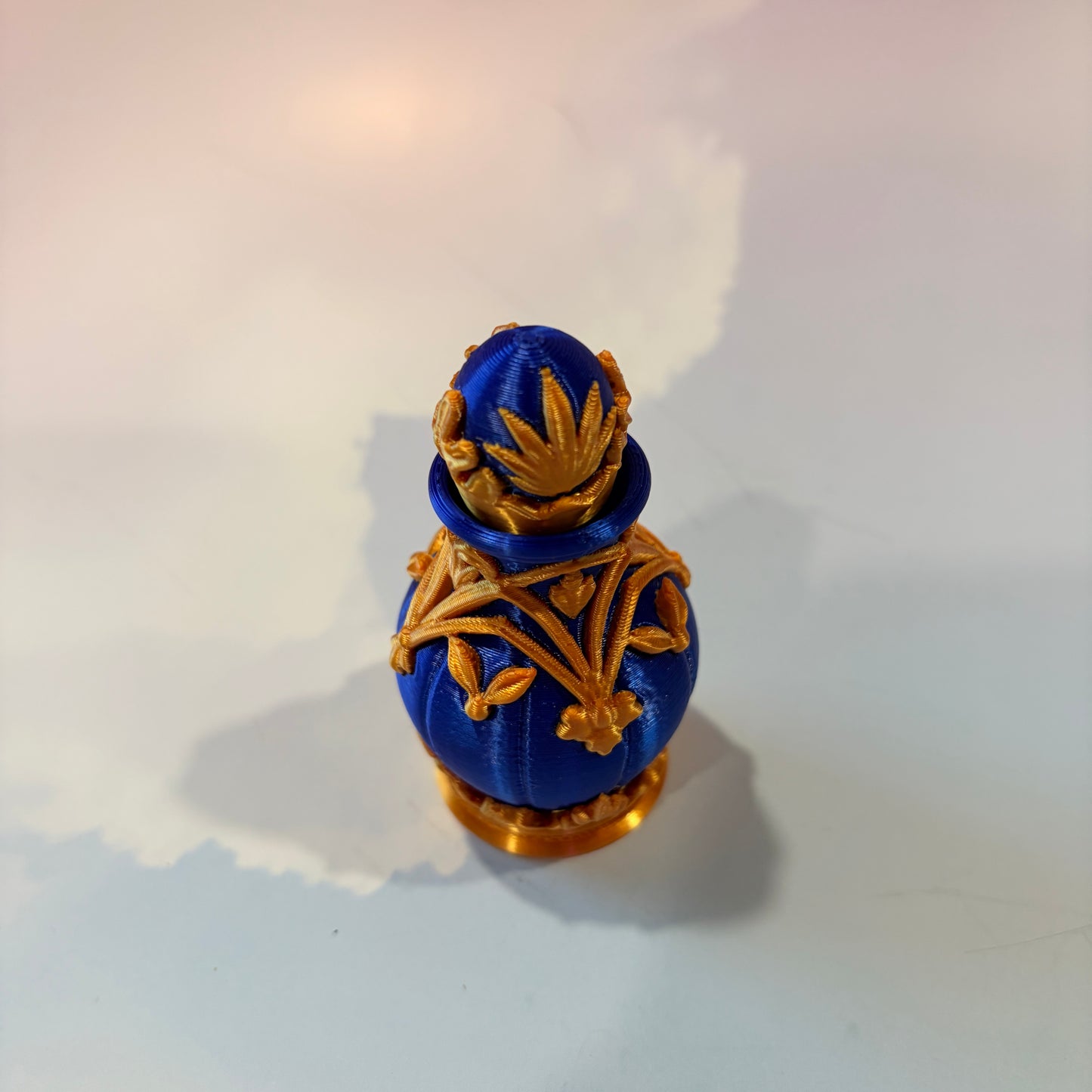 Royal blue and gold 3D printed potion bottle fidget clicker with ornate fantasy details, available in clicky or silent versions.
