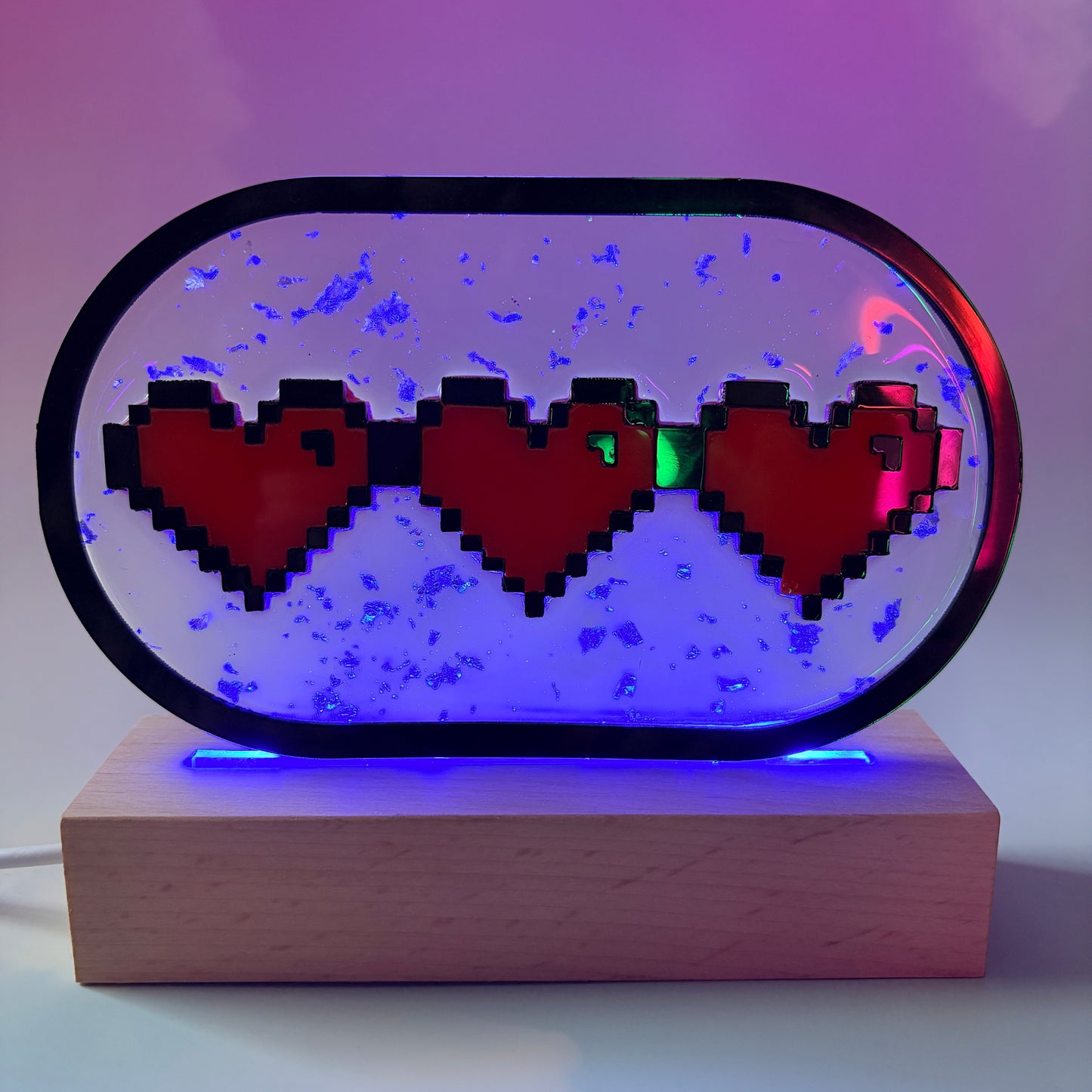 Handmade LED pixel heart container light with a hand-poured resin panel, silver leaf accents, laser-cut acrylic hearts, and customizable RGB lighting.