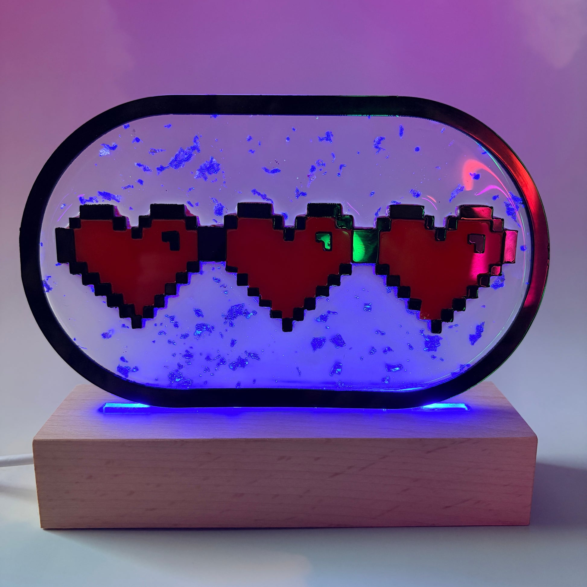 Handmade LED pixel heart container light with a hand-poured resin panel, silver leaf accents, laser-cut acrylic hearts, and customizable RGB lighting.