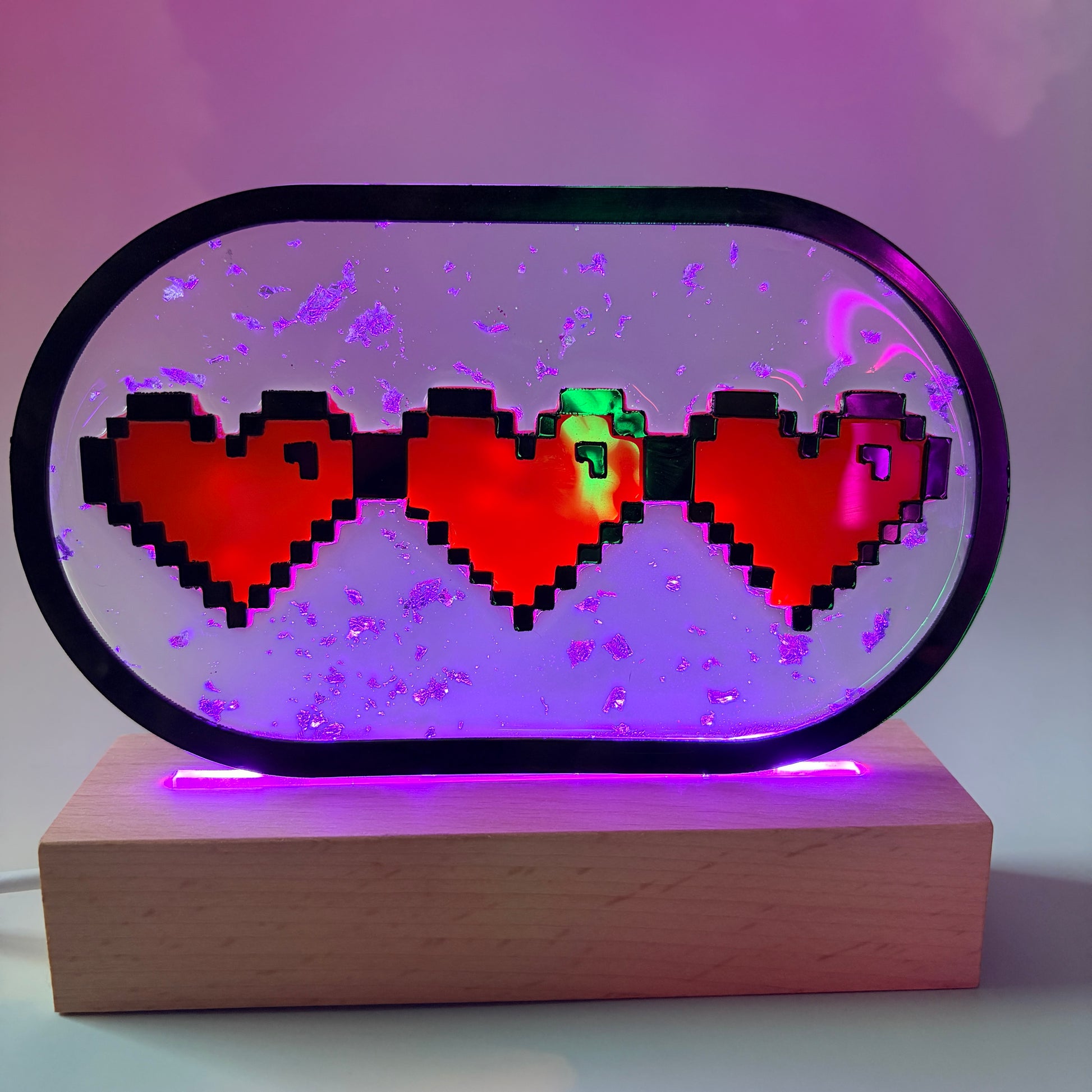 Handmade LED pixel heart container light with a hand-poured resin panel, silver leaf accents, laser-cut acrylic hearts, and customizable RGB lighting.