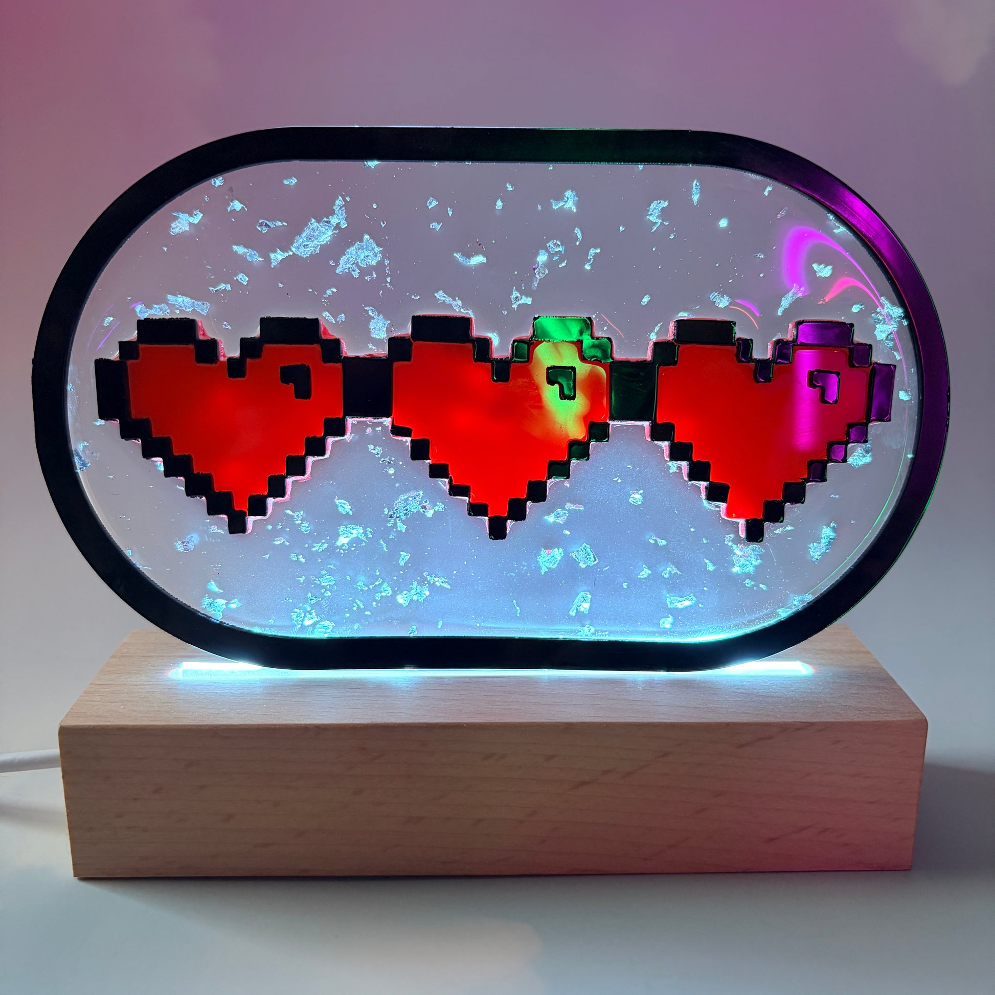 Handmade LED pixel heart container light with a hand-poured resin panel, silver leaf accents, laser-cut acrylic hearts, and customizable RGB lighting.