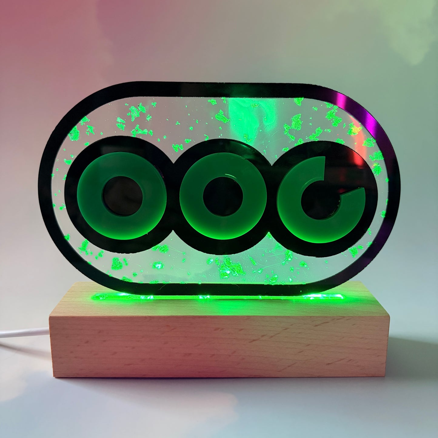 Handmade stamina wheel LED lamp with a hand-poured resin panel, silver leaf accents, laser-cut green acrylic design, and customizable RGB lighting.
