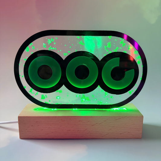 Handmade stamina wheel LED lamp with a hand-poured resin panel, silver leaf accents, laser-cut green acrylic design, and customizable RGB lighting.