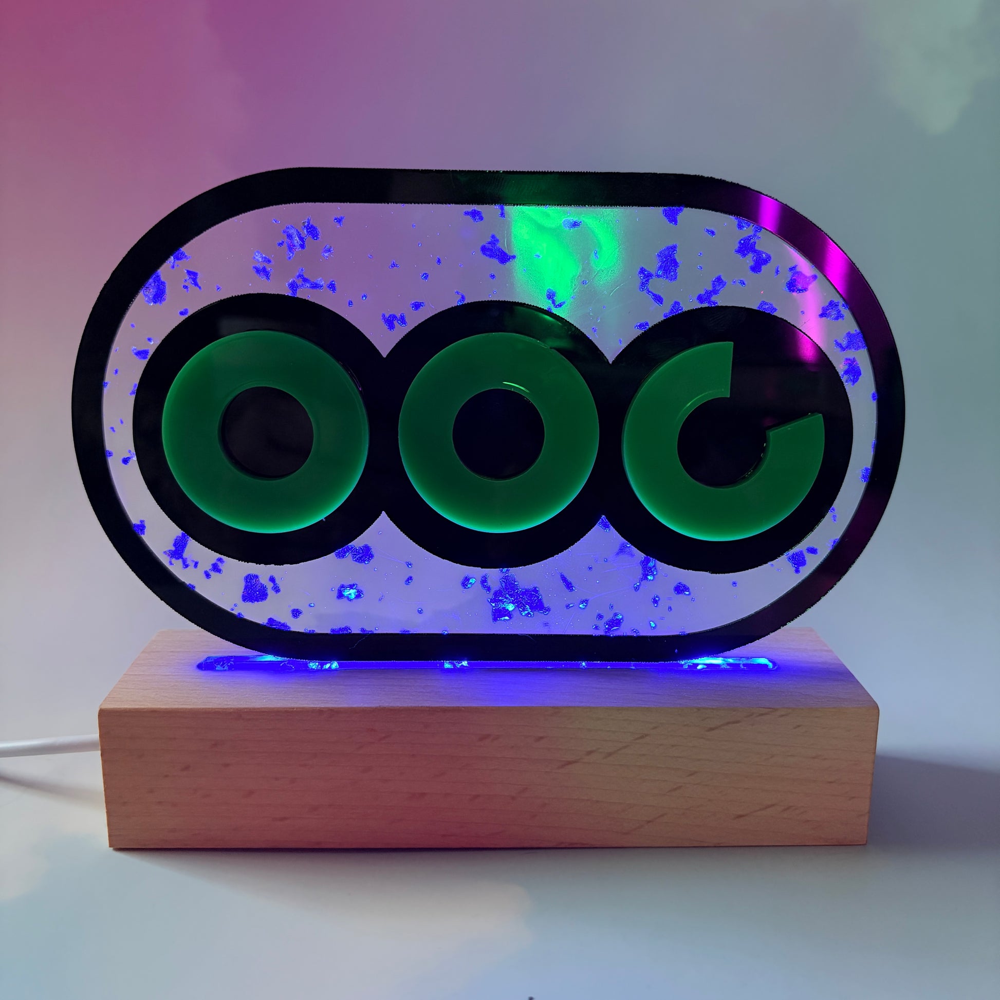 Handmade stamina wheel LED lamp with a hand-poured resin panel, silver leaf accents, laser-cut green acrylic design, and customizable RGB lighting.